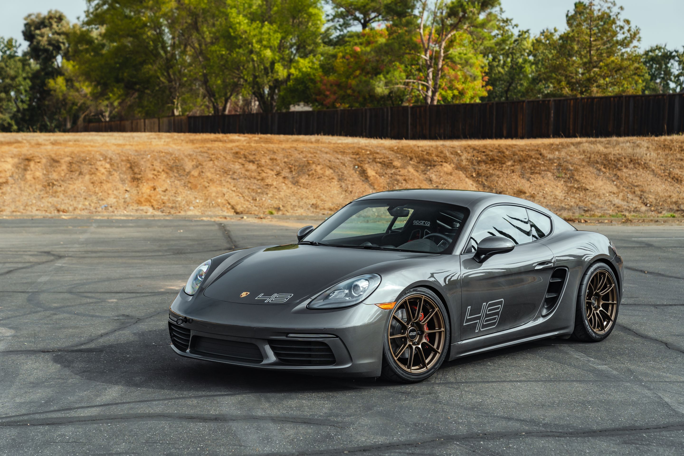 Grey Porsche 718 Cayman S with 19" SM-10RS Apex wheels in Satin Bronze