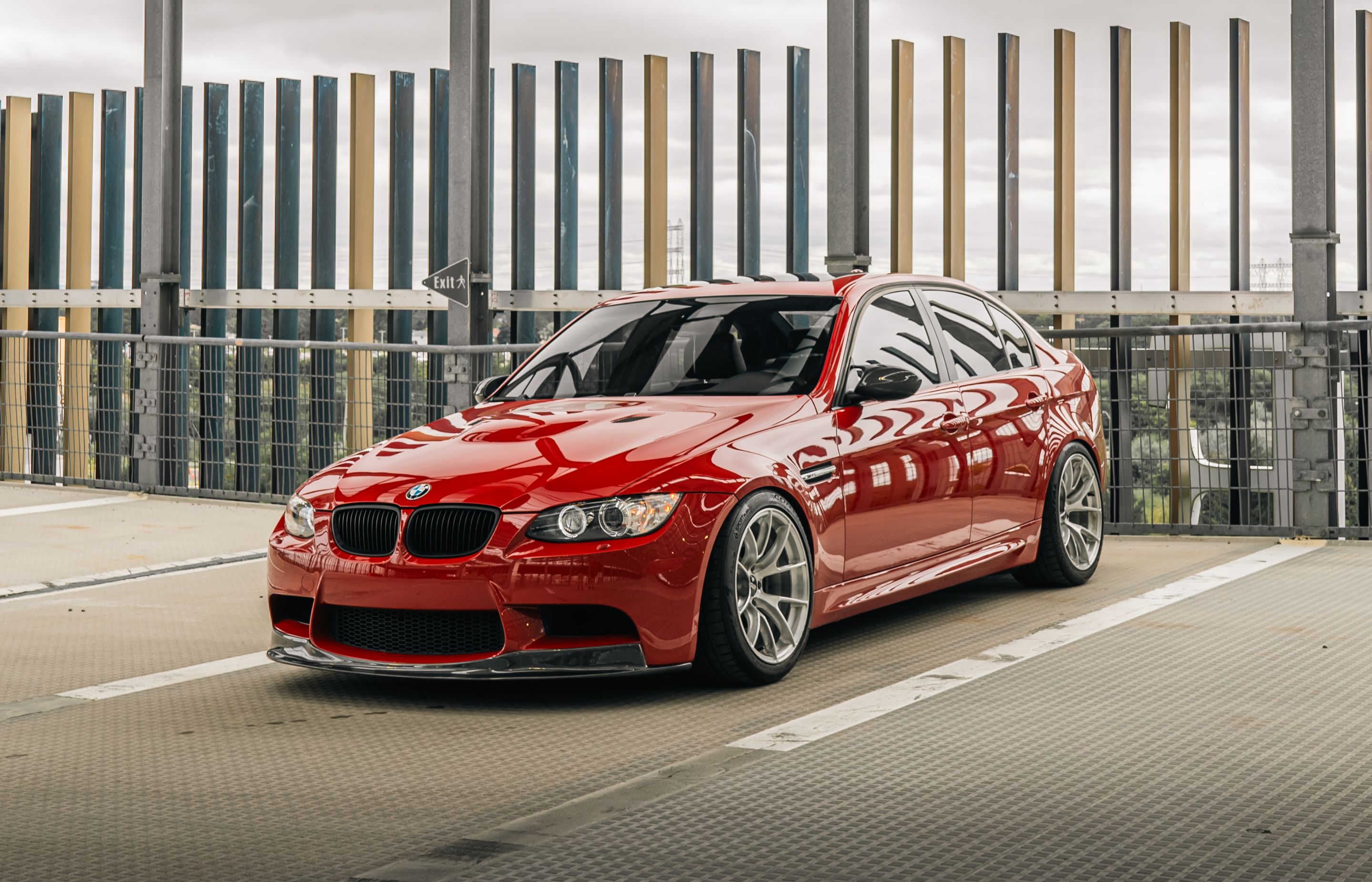 Red BMW E90 Sedan M3 with 18" VS-5RS Apex wheels in Brushed Clear