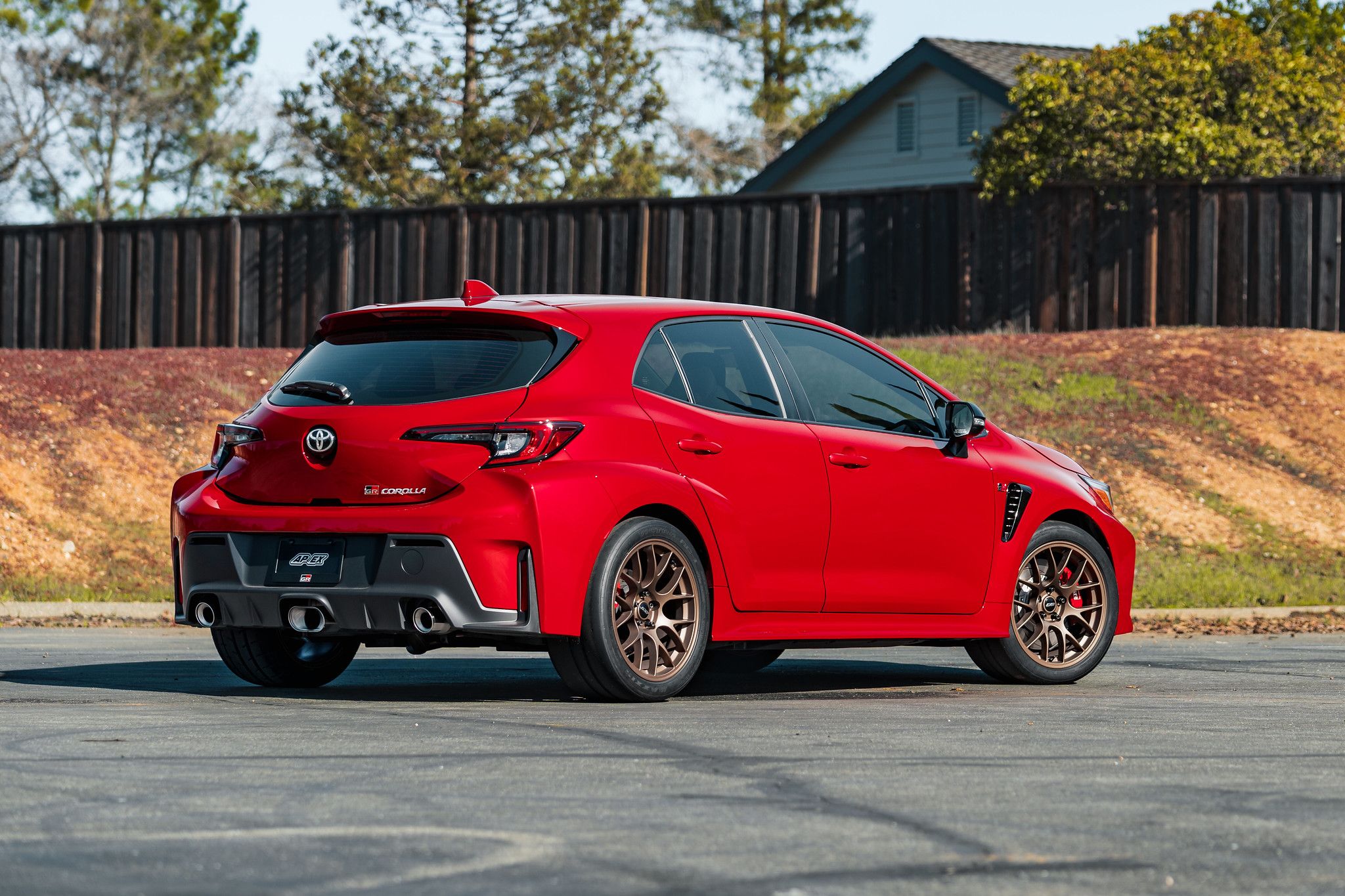 Red Toyota GR Corolla with 18" EC-7 Apex wheels in Satin Bronze