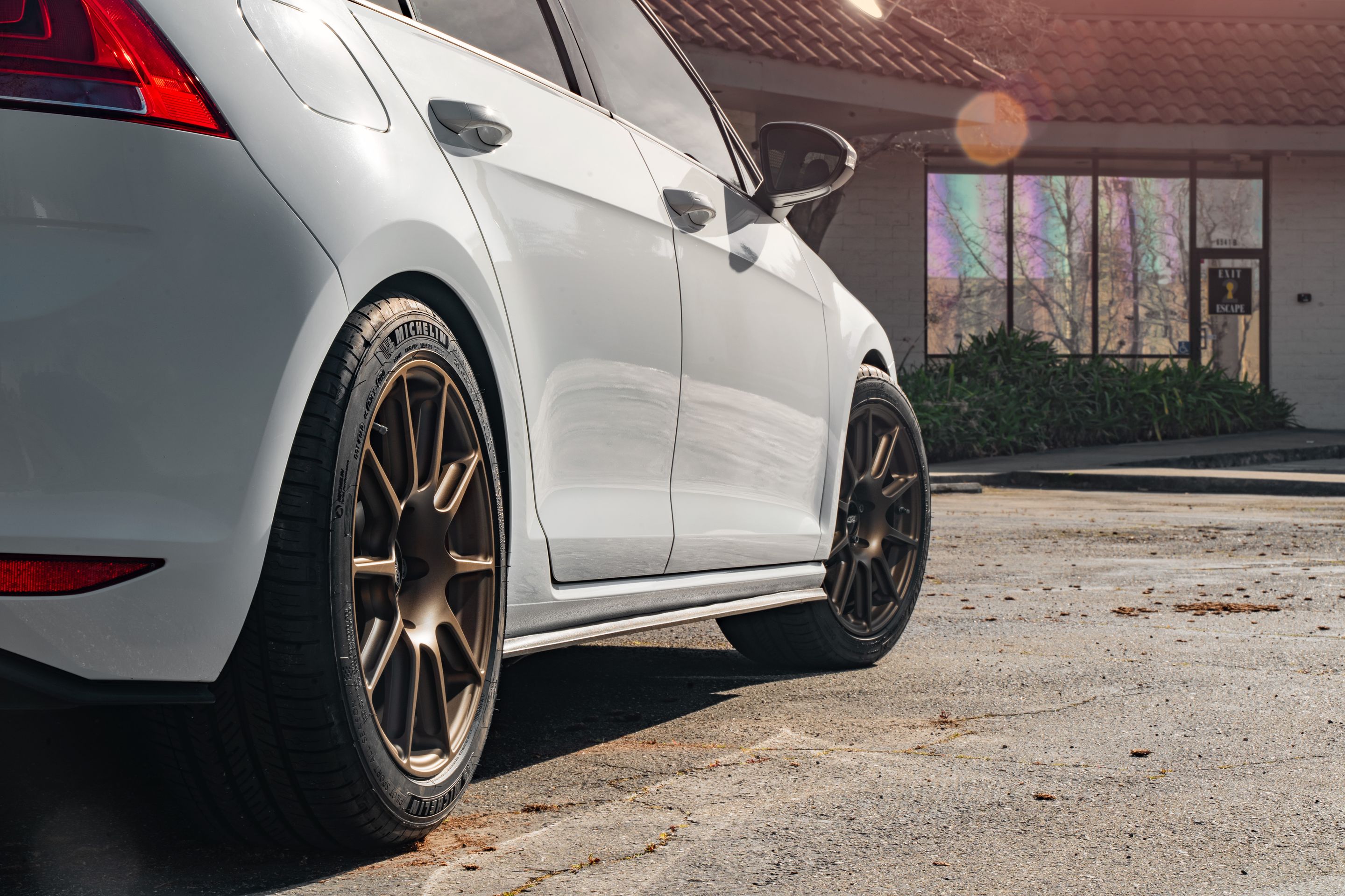 White VW MK7 GTI with 17" SM-10 Apex wheels in Satin Bronze