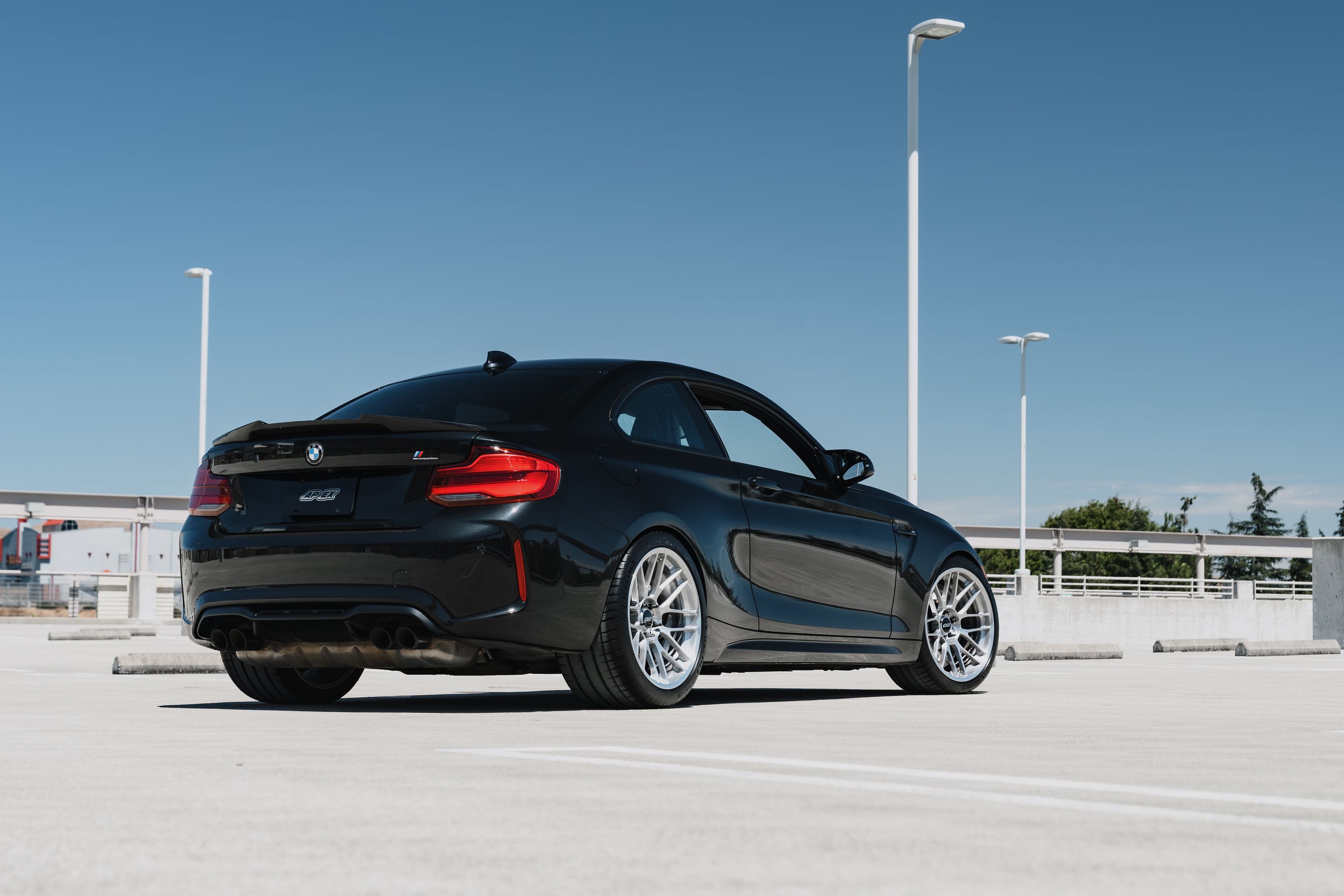 Black BMW F87 M2 with 19" ARC-8RT Apex wheels in Brushed Clear