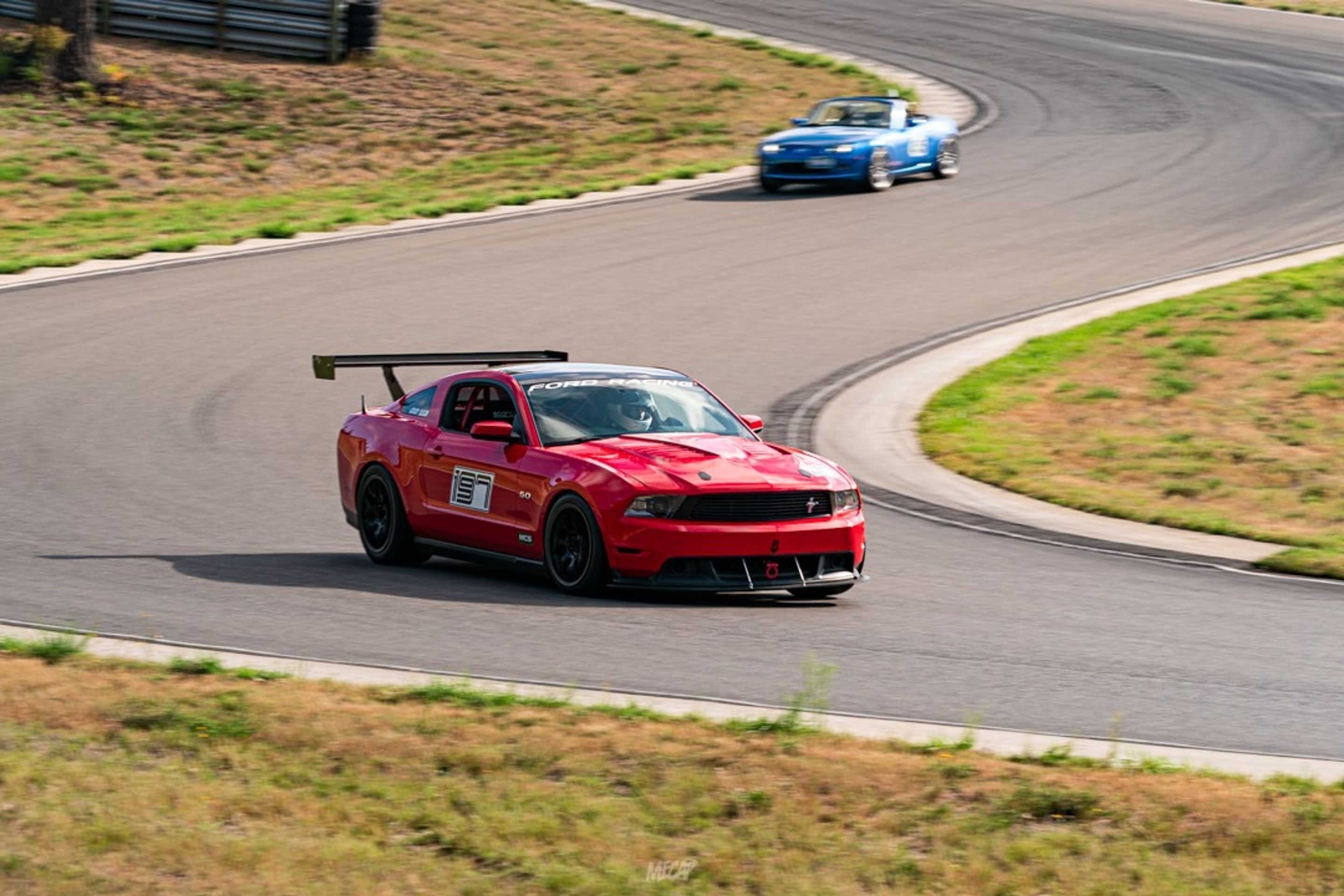 Red Ford S197 Mustang GT with 18" EC-7 Apex wheels in Satin Black