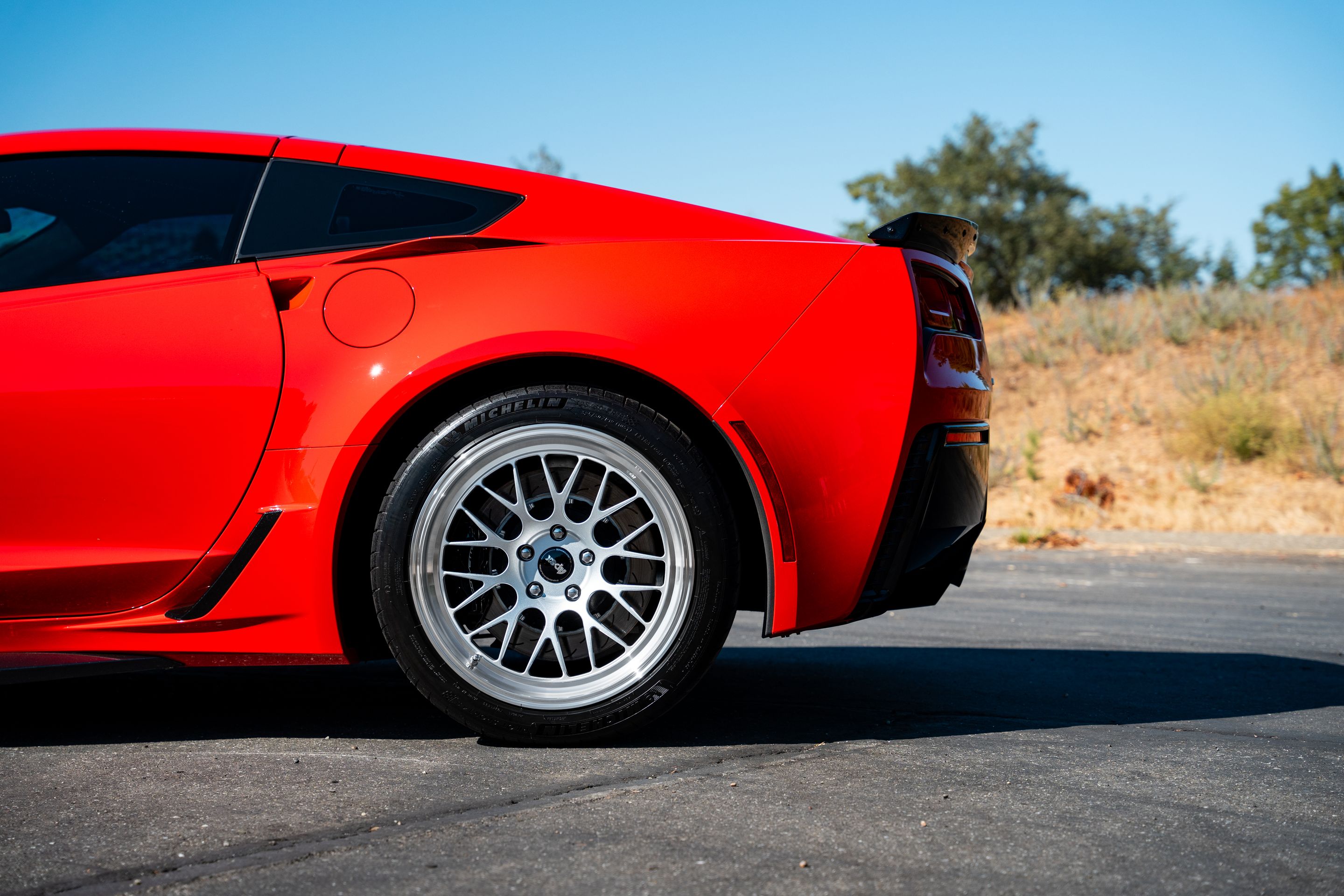 Red Chevrolet C7 Corvette Grand Sport with 18"/19" ML-10RT Apex wheels in Machined Lip Race Silver