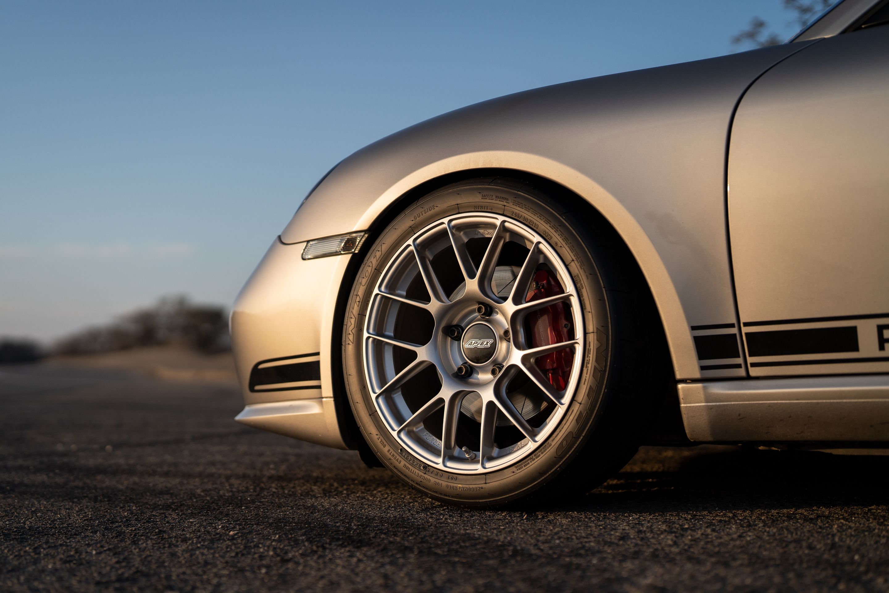 Grey Porsche 987 Cayman R with 18" EC-7RS Apex wheels in Race Silver