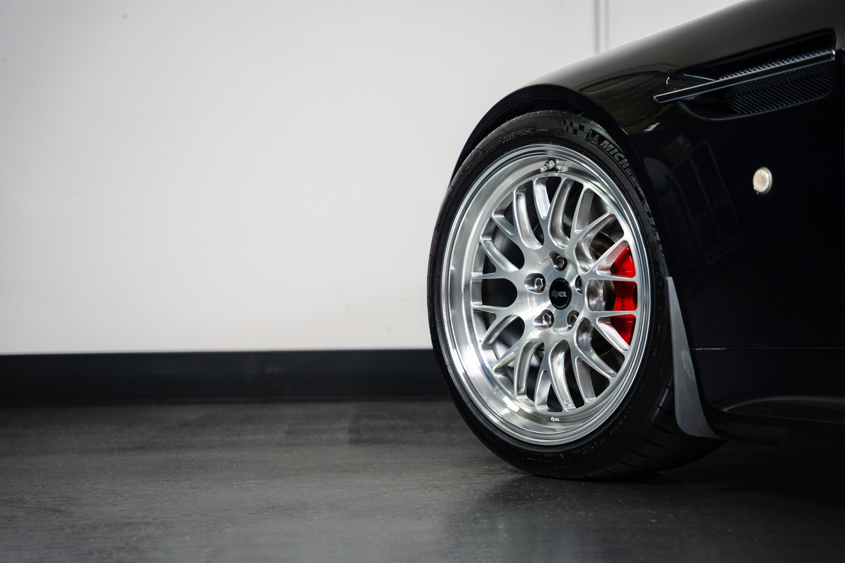 Black Aston Martin V8/V12 Vantage with 19" ML-10RT Apex wheels in Machined Lip Brushed Clear