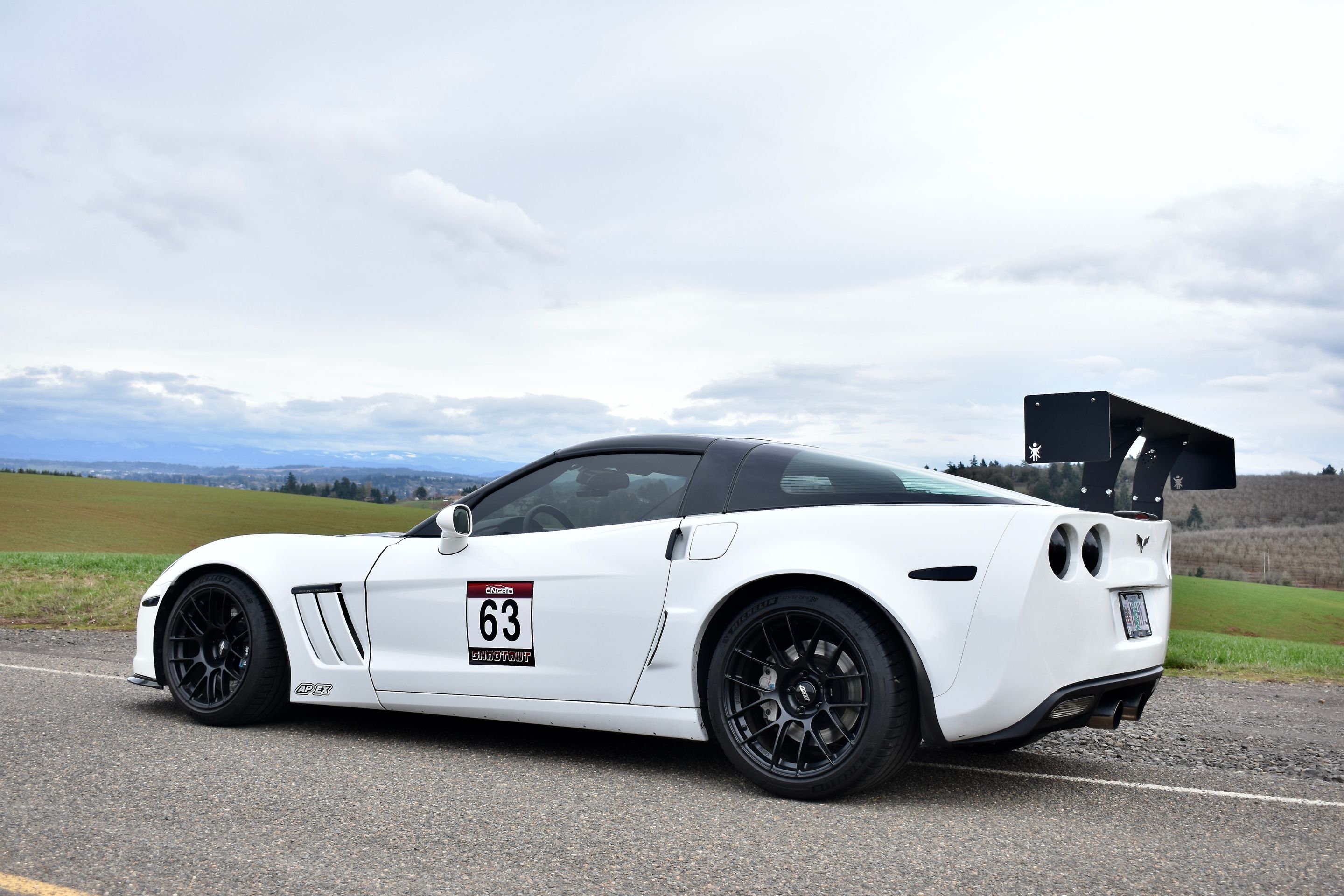 White Chevrolet C6 Corvette Grand Sport with 18"/19" EC-7RS Apex wheels in Satin Black