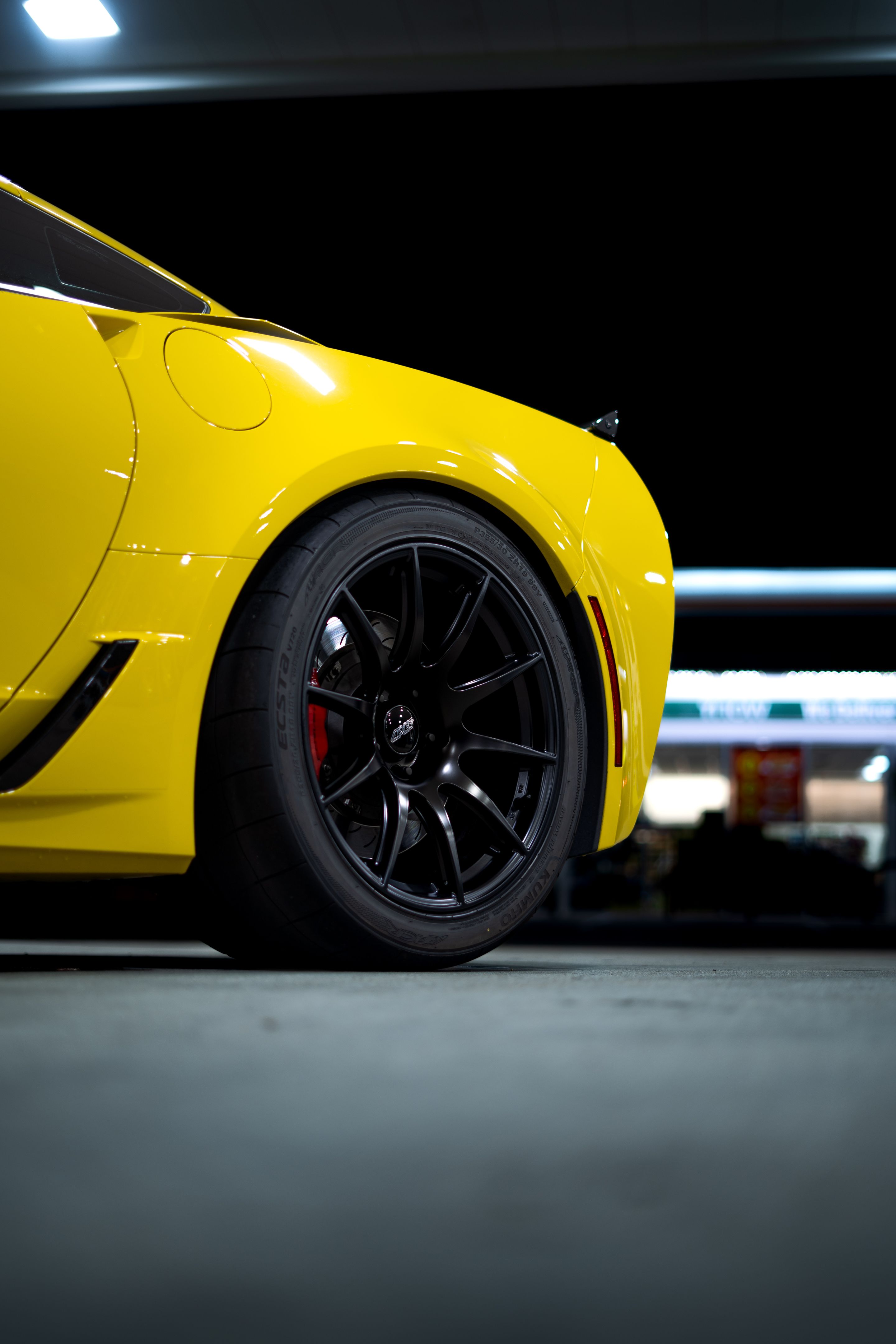 Yellow Chevrolet C7 Corvette Grand Sport with 19" SM-10 Apex wheels in Satin Black