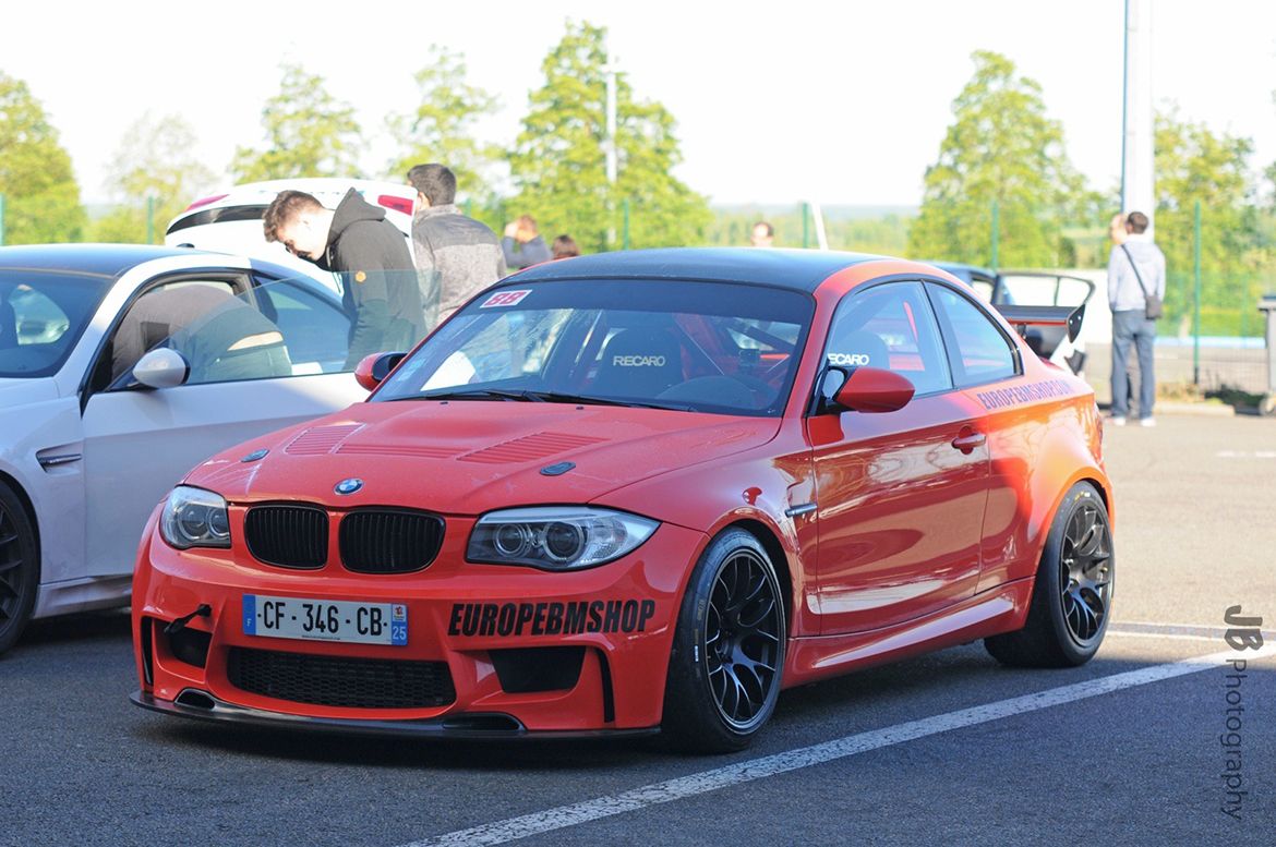 Orange BMW E82 1M with 18" EC-7 Apex wheels in Satin Black
