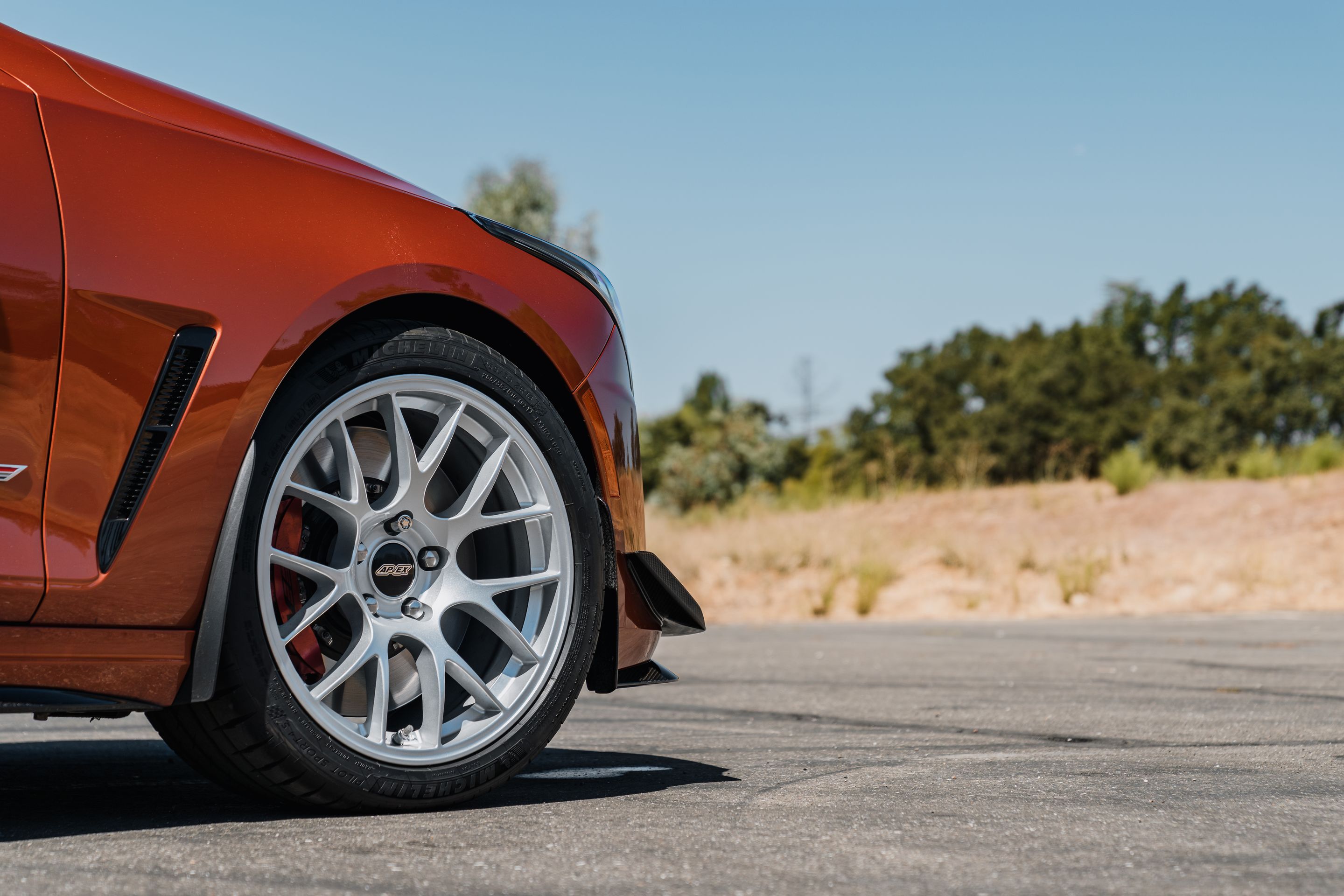 Orange Cadillac CT4-V Blackwing with 18" EC-7 Apex wheels in Race Silver