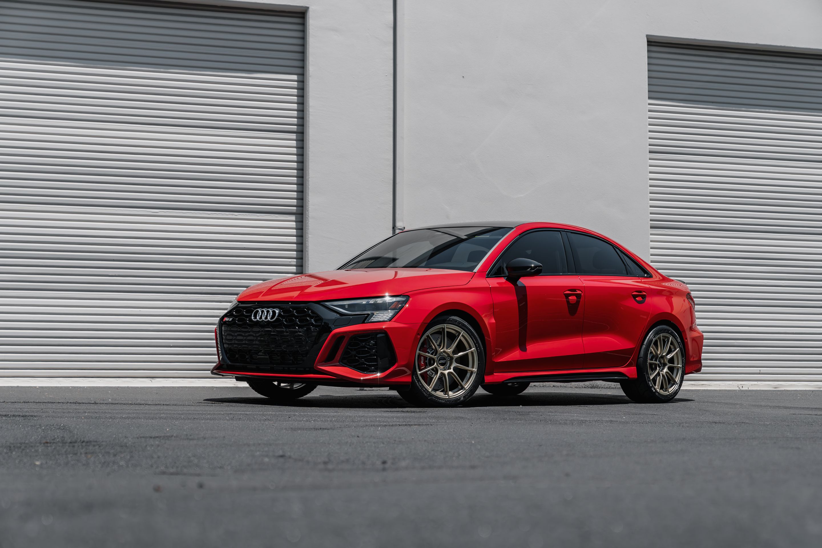 Red Audi 8Y RS 3 with 18" SM-10RS Apex wheels in Motorsport Gold