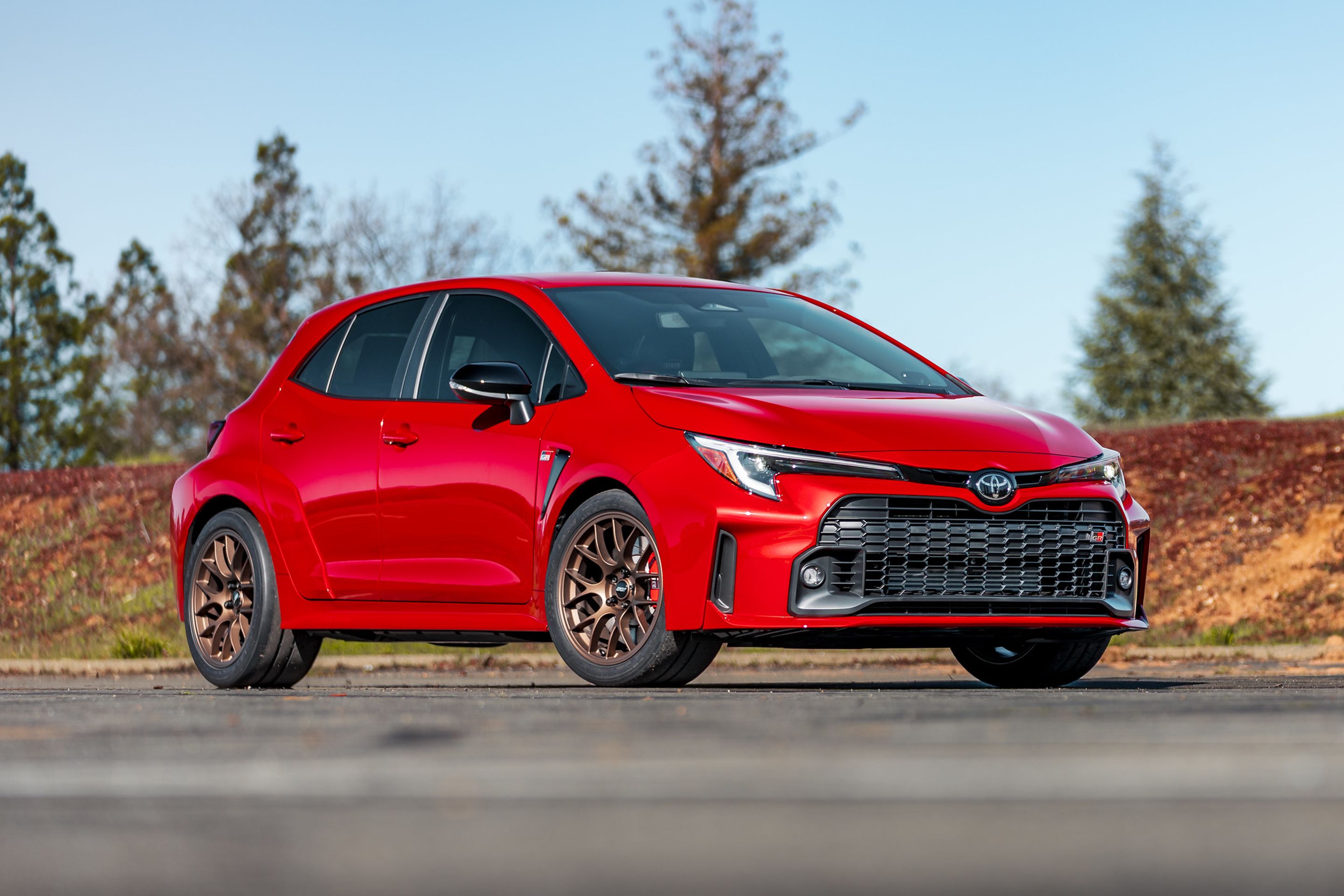 Red Toyota GR Corolla with 18" EC-7 Apex wheels in Satin Bronze