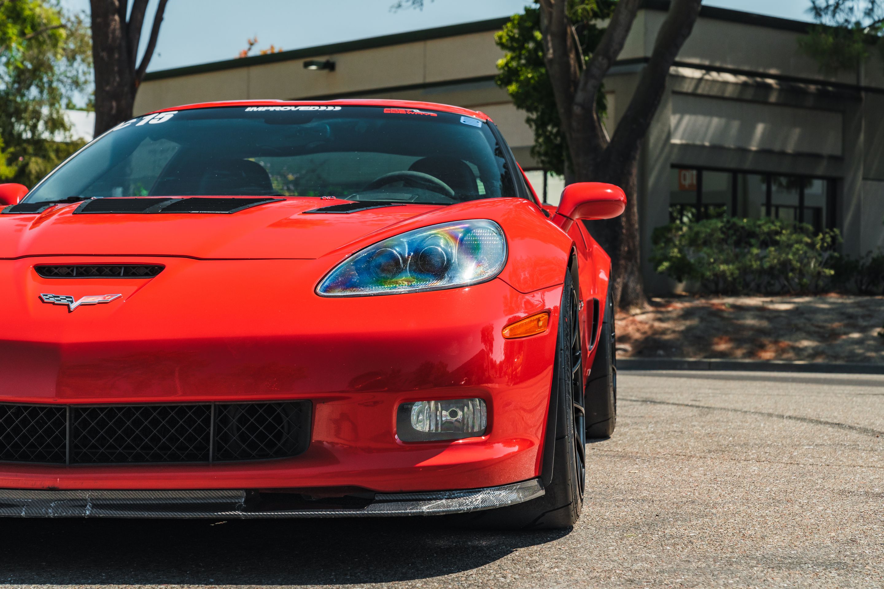 Red Chevrolet C6 Corvette Z06 with 18" SM-10RS Apex wheels in Satin Black