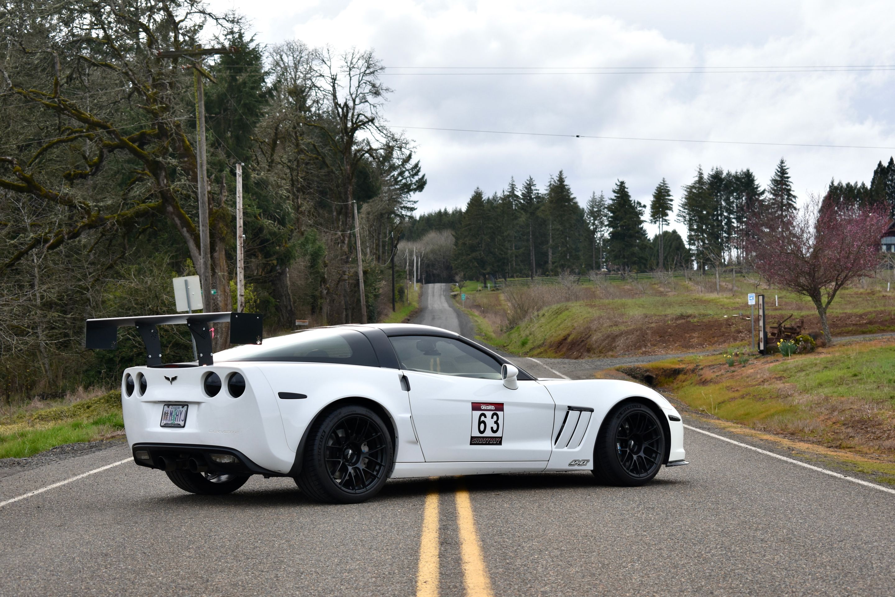 White Chevrolet C6 Corvette Grand Sport with 18"/19" EC-7RS Apex wheels in Satin Black
