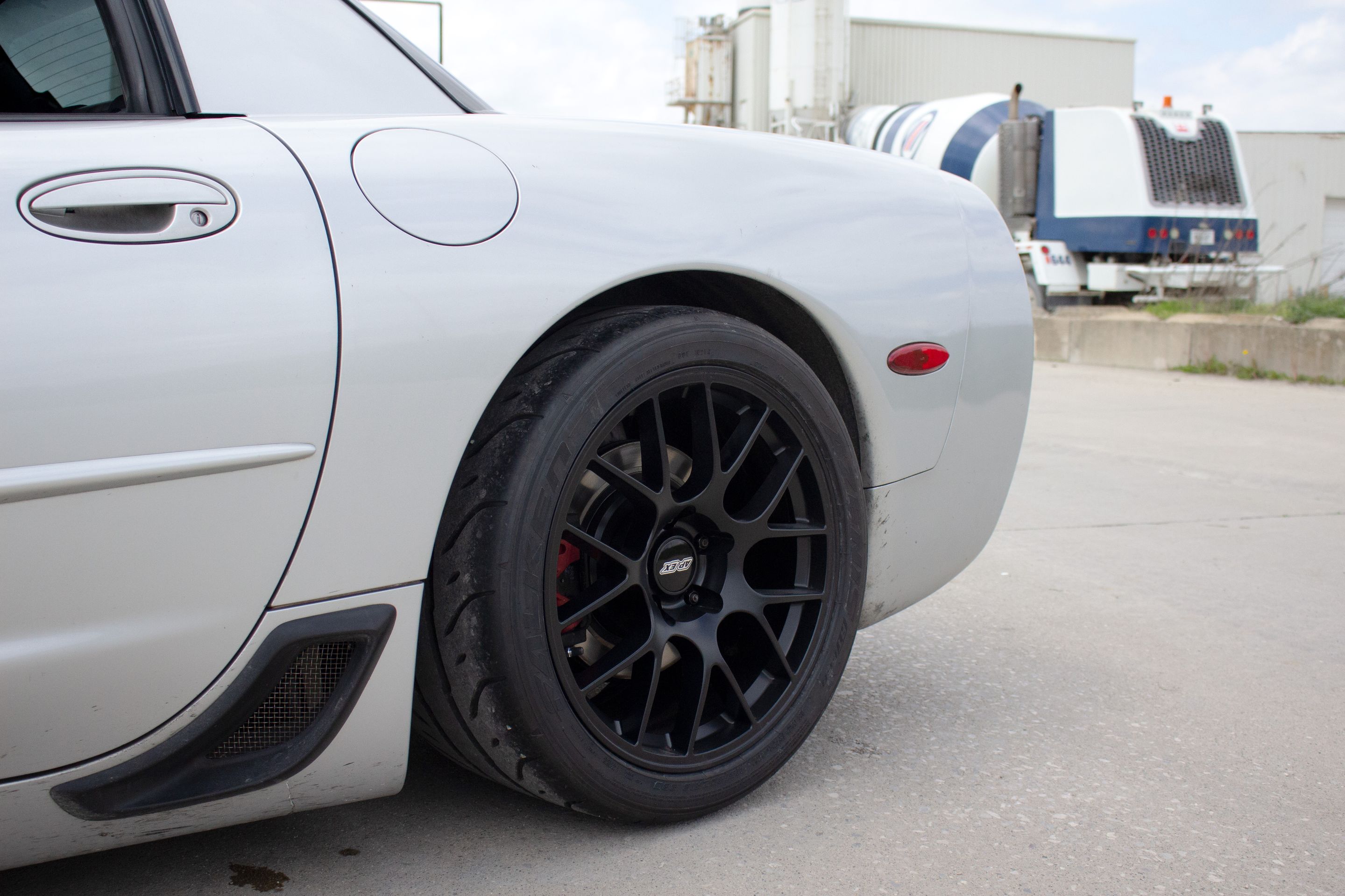Silver Chevrolet C5 Corvette Z06 with 18" EC-7 Apex wheels in Satin Black