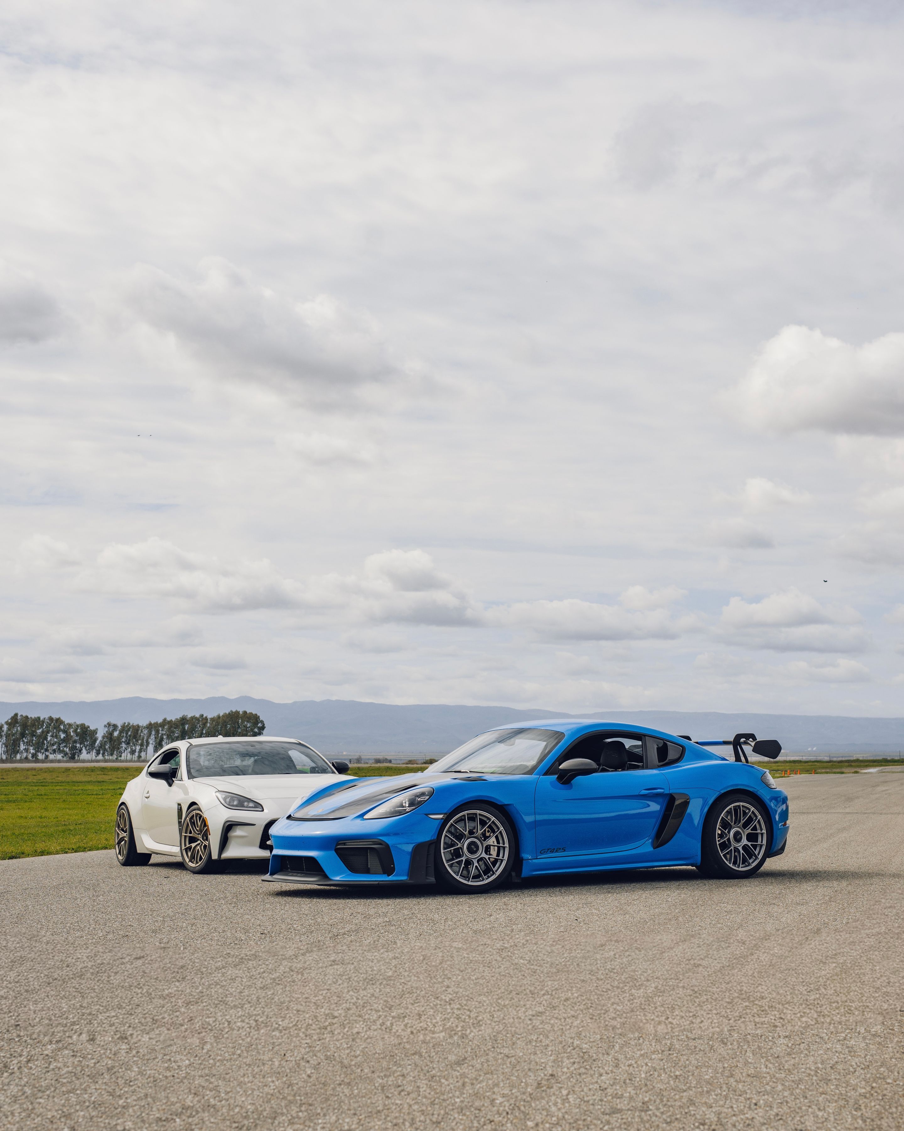 Blue Porsche 718 Cayman GT4 RS with 19" EC-7RS Apex wheels in Race Silver