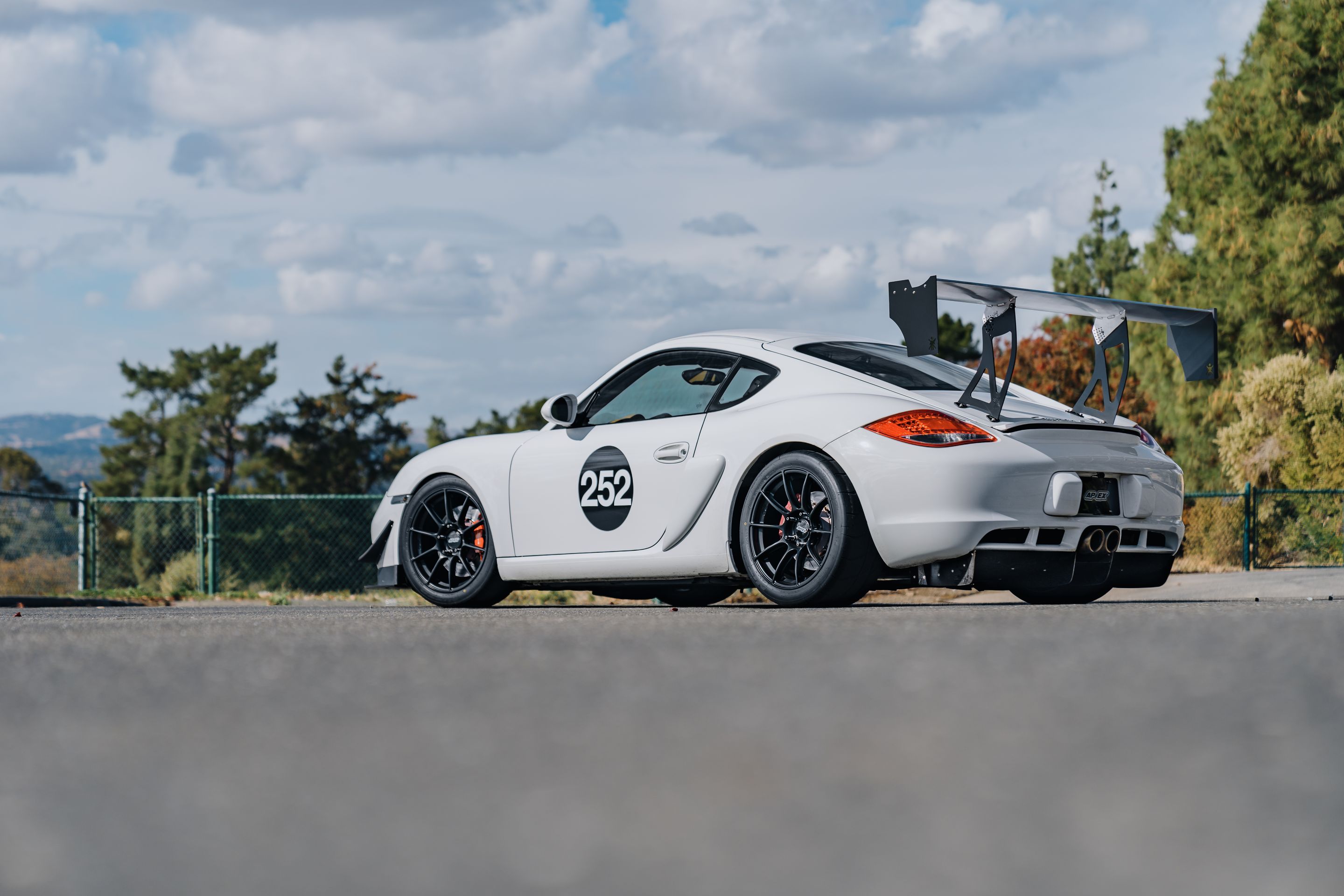 White Porsche 987 Cayman S with 18" SM-10RS Apex wheels in Satin Black