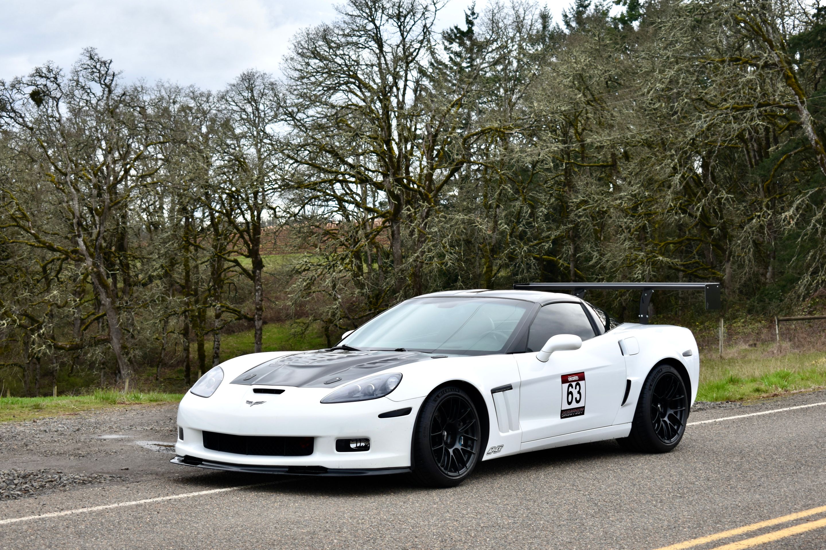 White Chevrolet C6 Corvette Grand Sport with 18"/19" EC-7RS Apex wheels in Satin Black