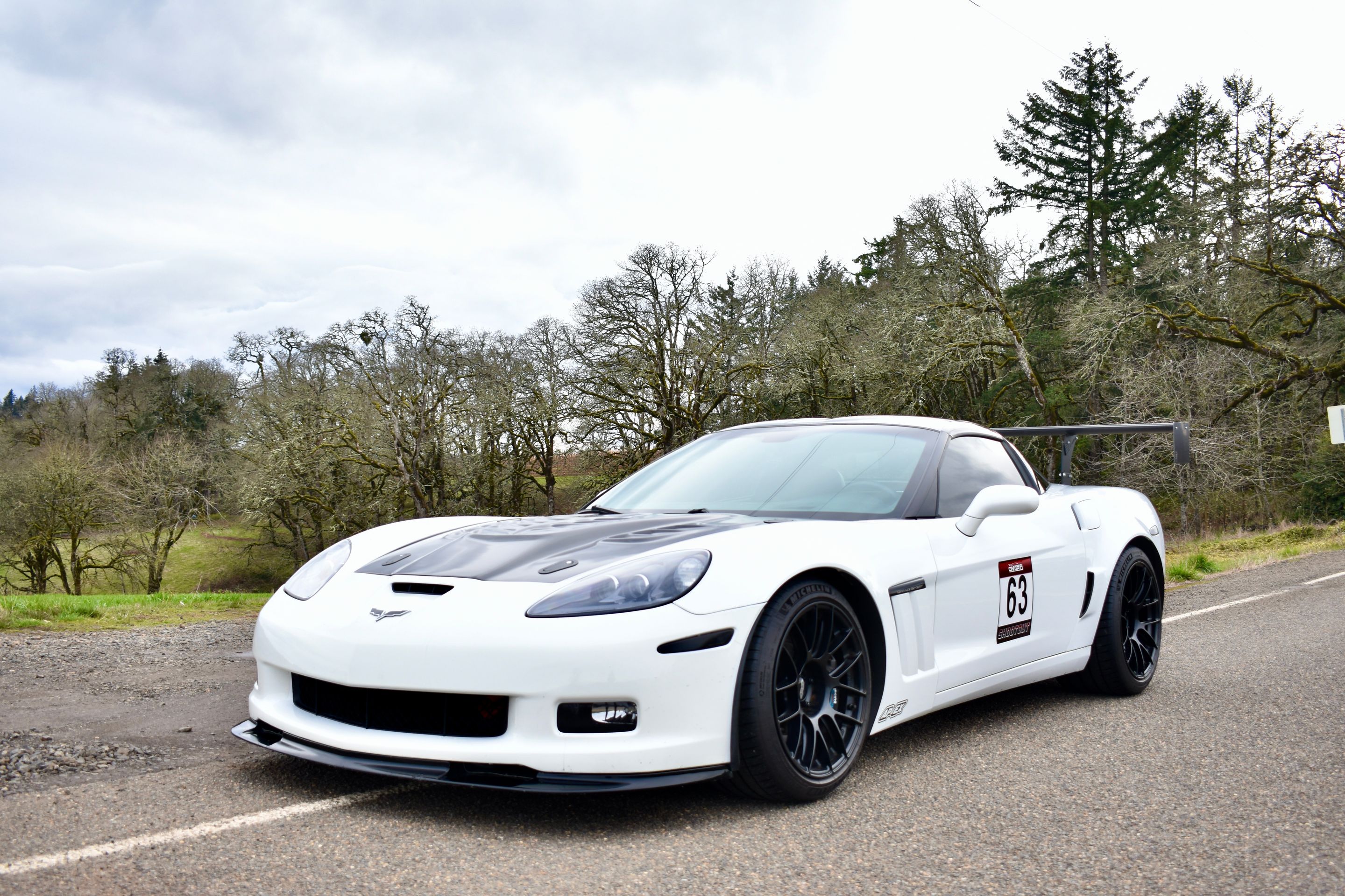 White Chevrolet C6 Corvette Grand Sport with 18"/19" EC-7RS Apex wheels in Satin Black