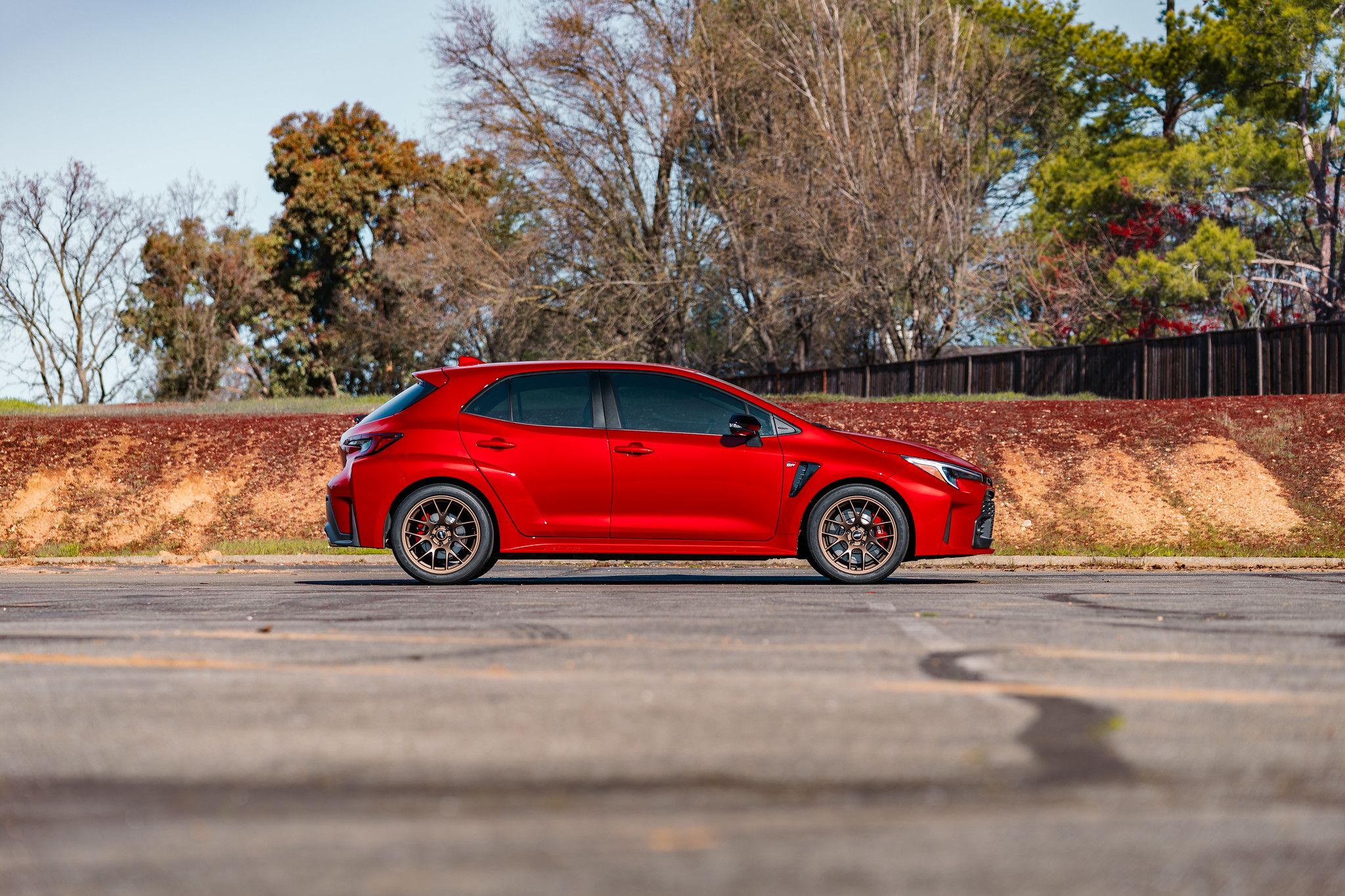 Red Toyota GR Corolla with 18" EC-7 Apex wheels in Satin Bronze
