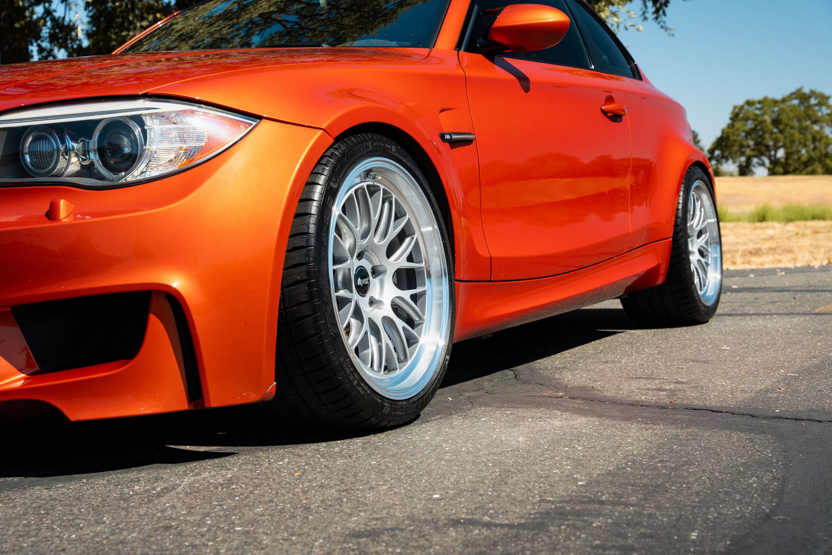 Orange BMW E82 1M with 19" ML-10RT Apex wheels in Machined Lip Race Silver