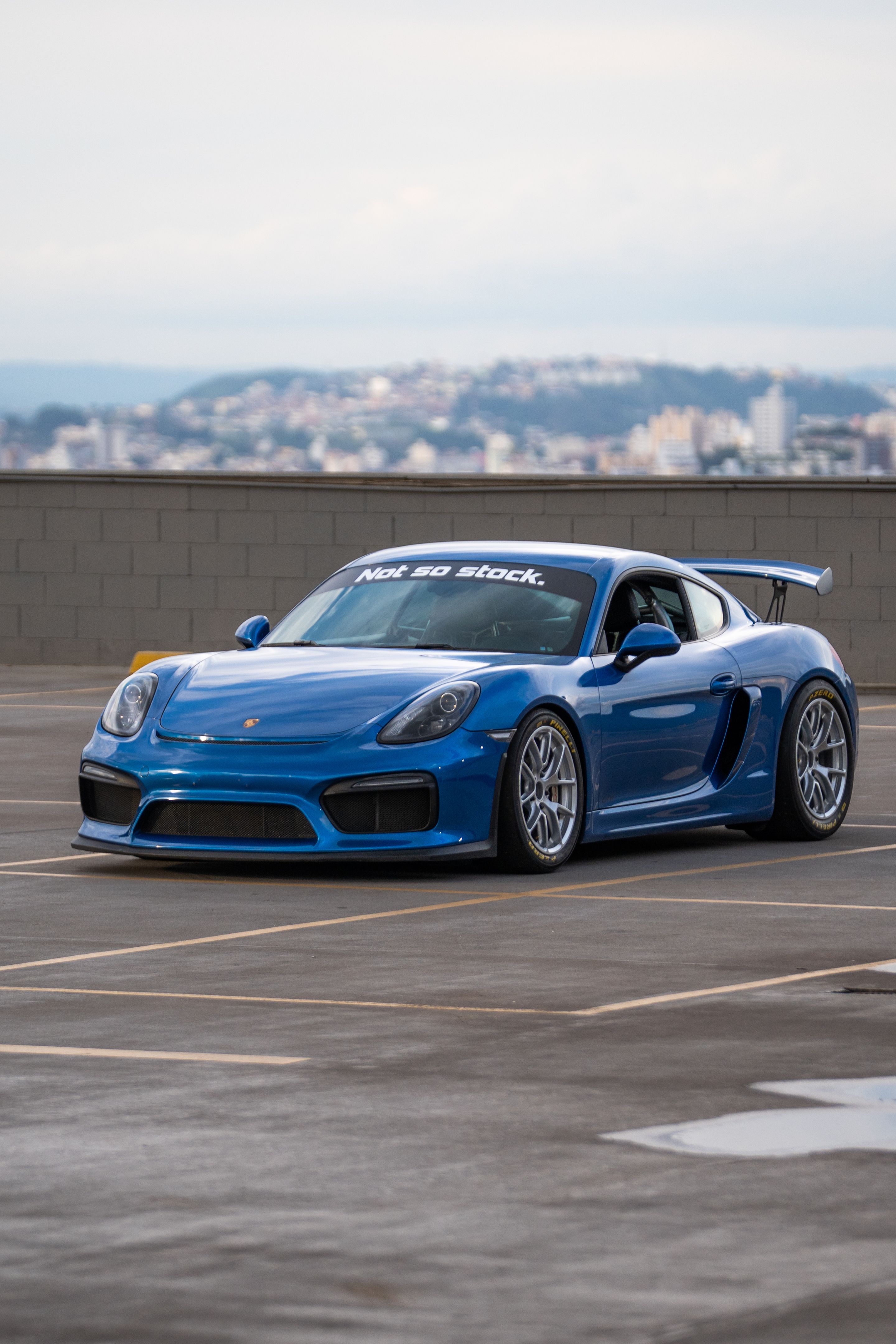 Blue Porsche 981 Cayman GT4 with 18" VS-5RE Apex wheels in Race Silver