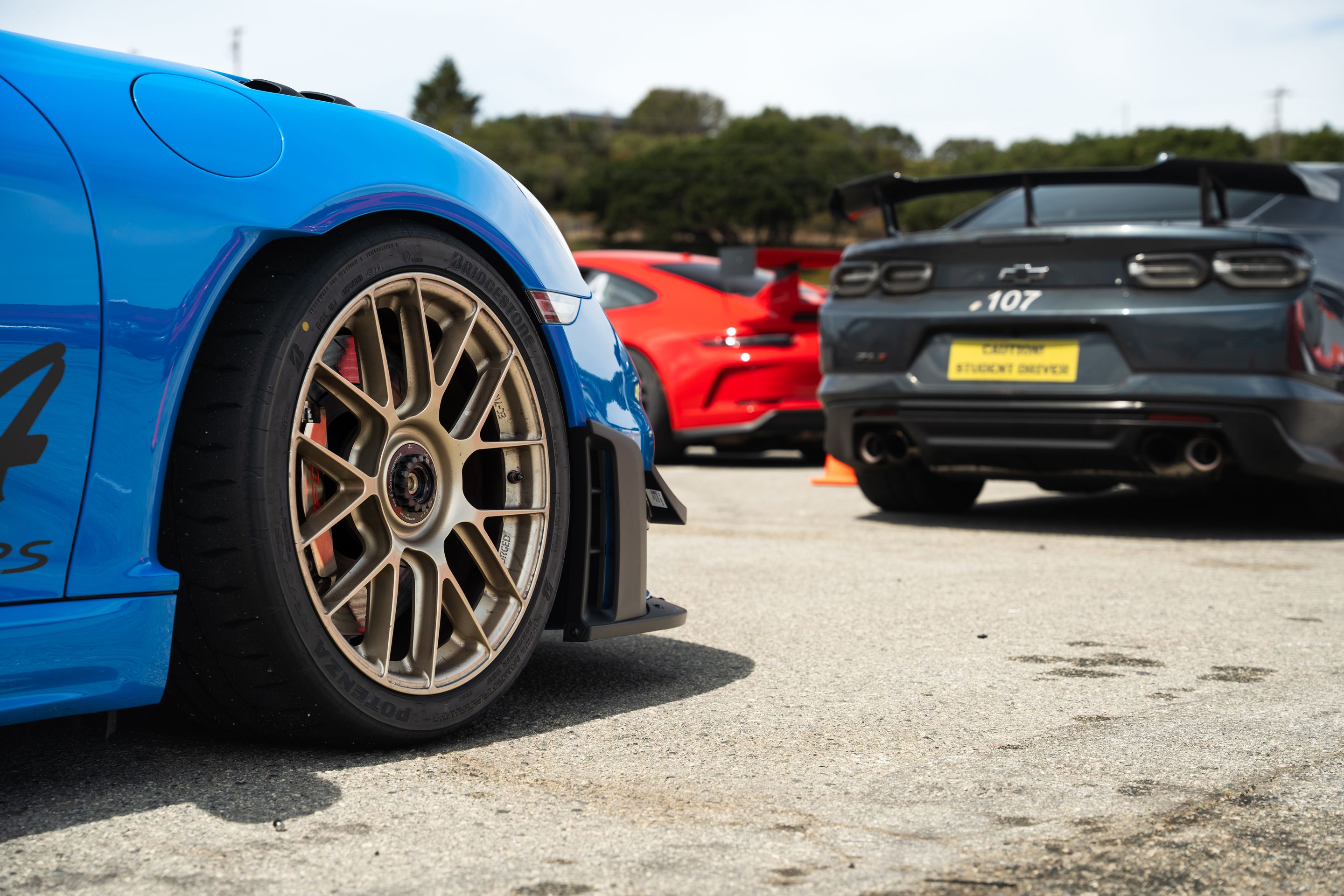 Blue Porsche 718 Cayman GT4 RS with 19" EC-7RS Apex wheels in Motorsport Gold