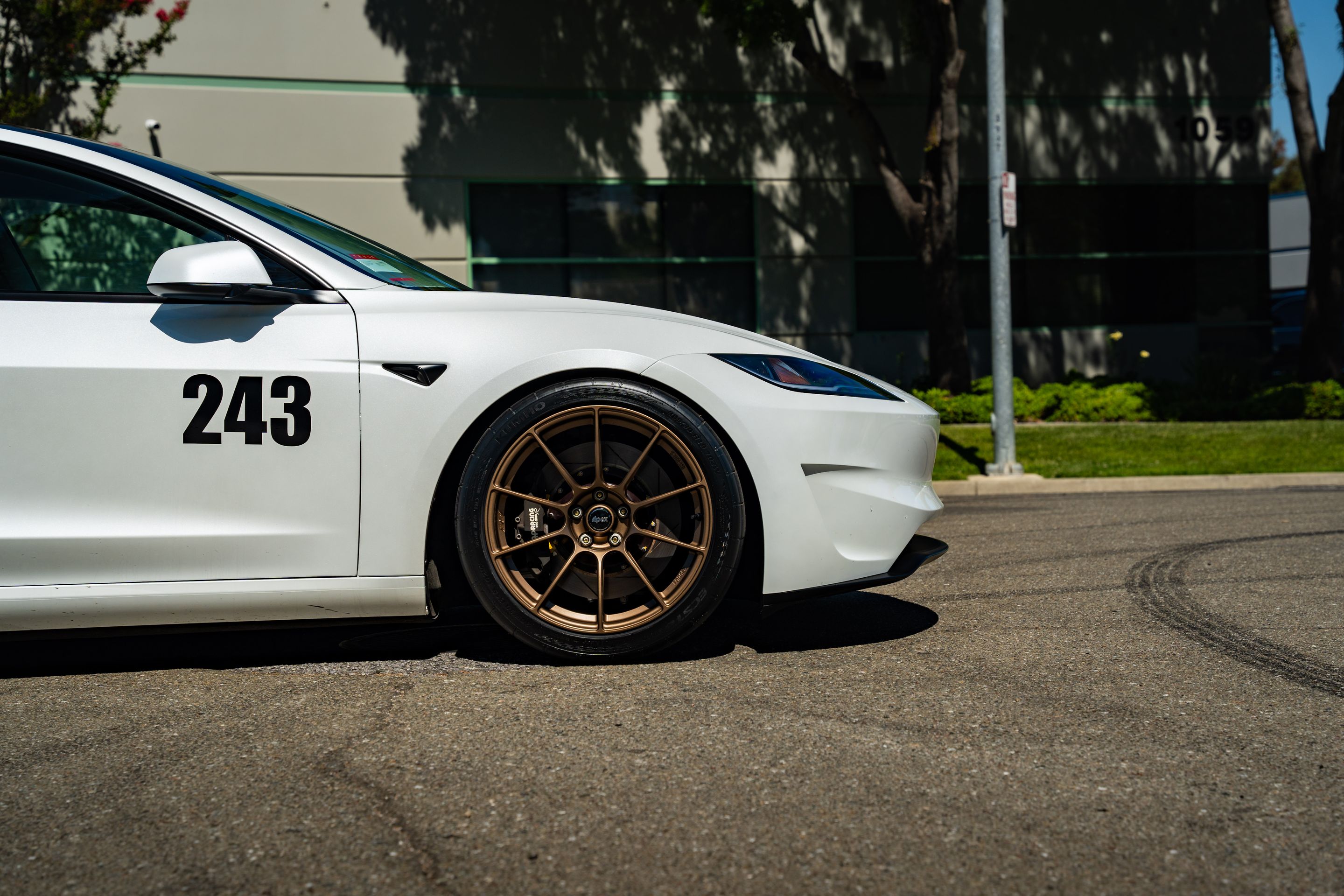 White Tesla Model 3 with 19" SM-10RS Apex wheels in Satin Bronze