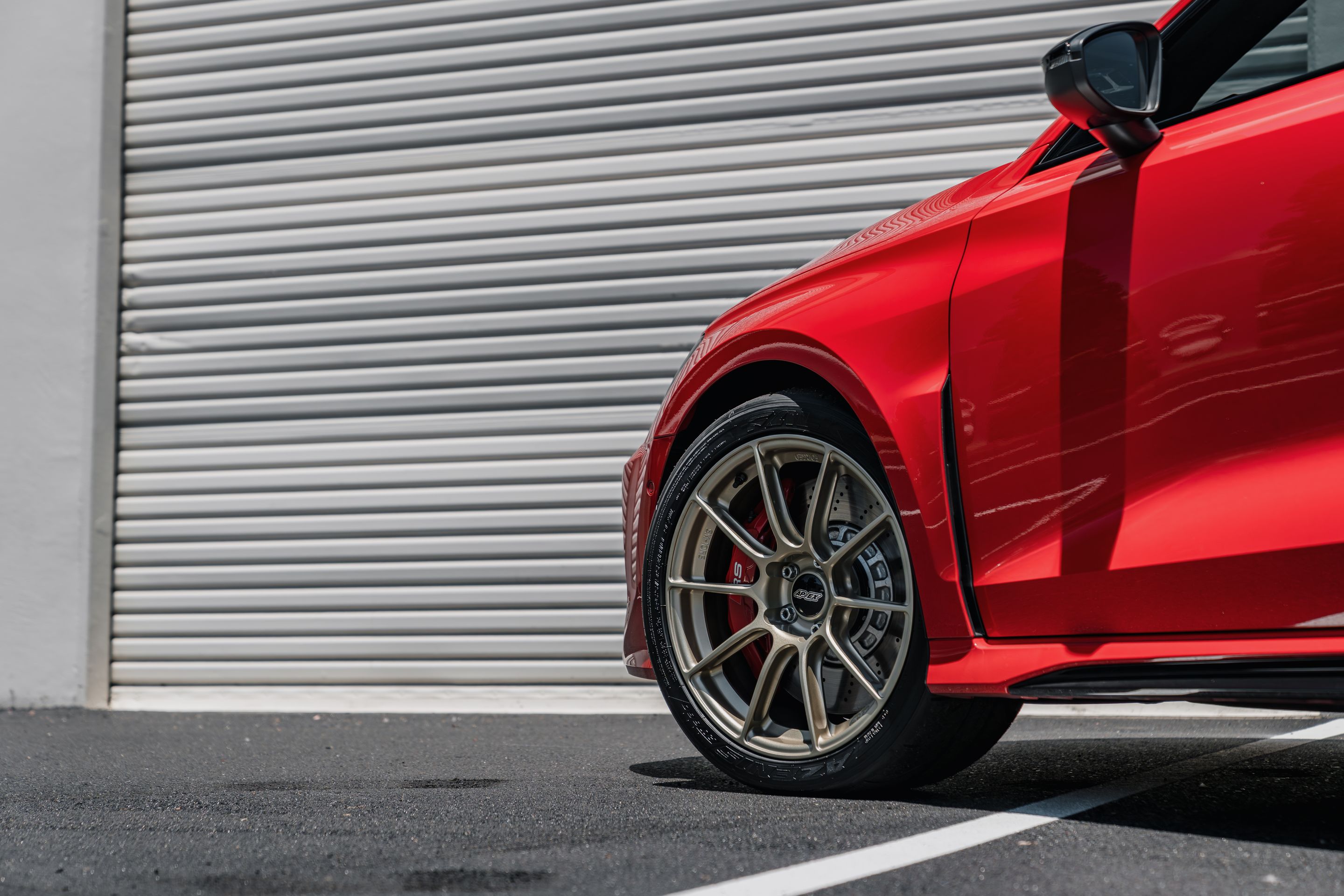 Red Audi 8Y RS 3 with 18" SM-10RS Apex wheels in Motorsport Gold