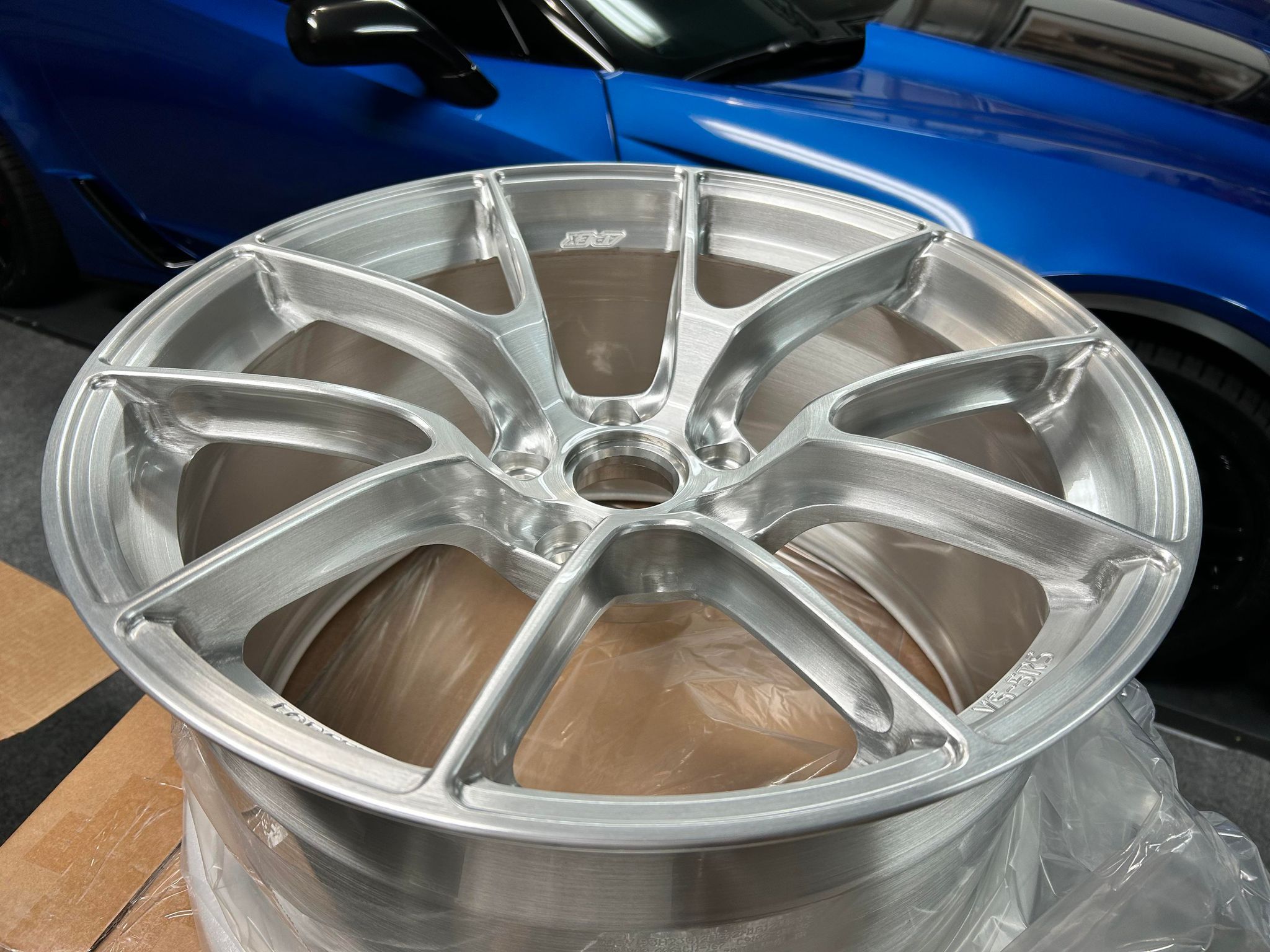 Blue Chevrolet C7 Corvette Z06 with 19"/20" VS-5RS Apex wheels in Brushed Clear
