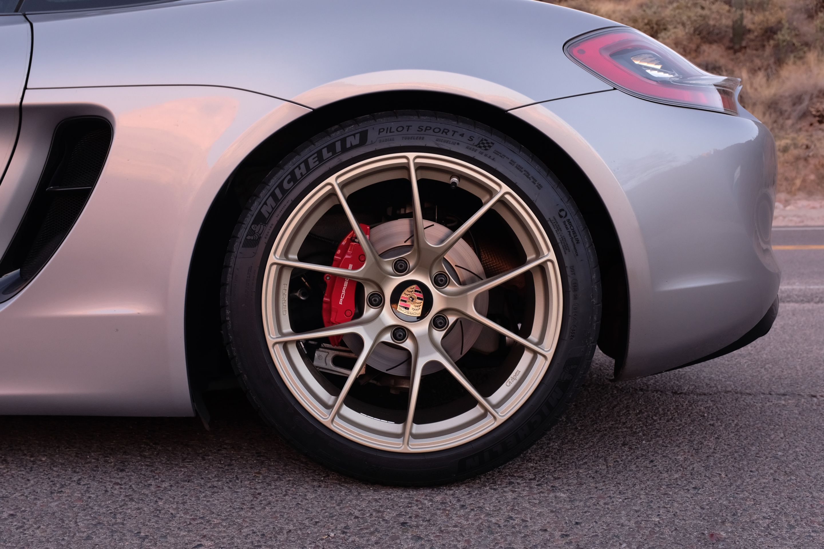 Silver Porsche 981 Cayman GTS with 19" VS-5RS Apex wheels in Motorsport Gold