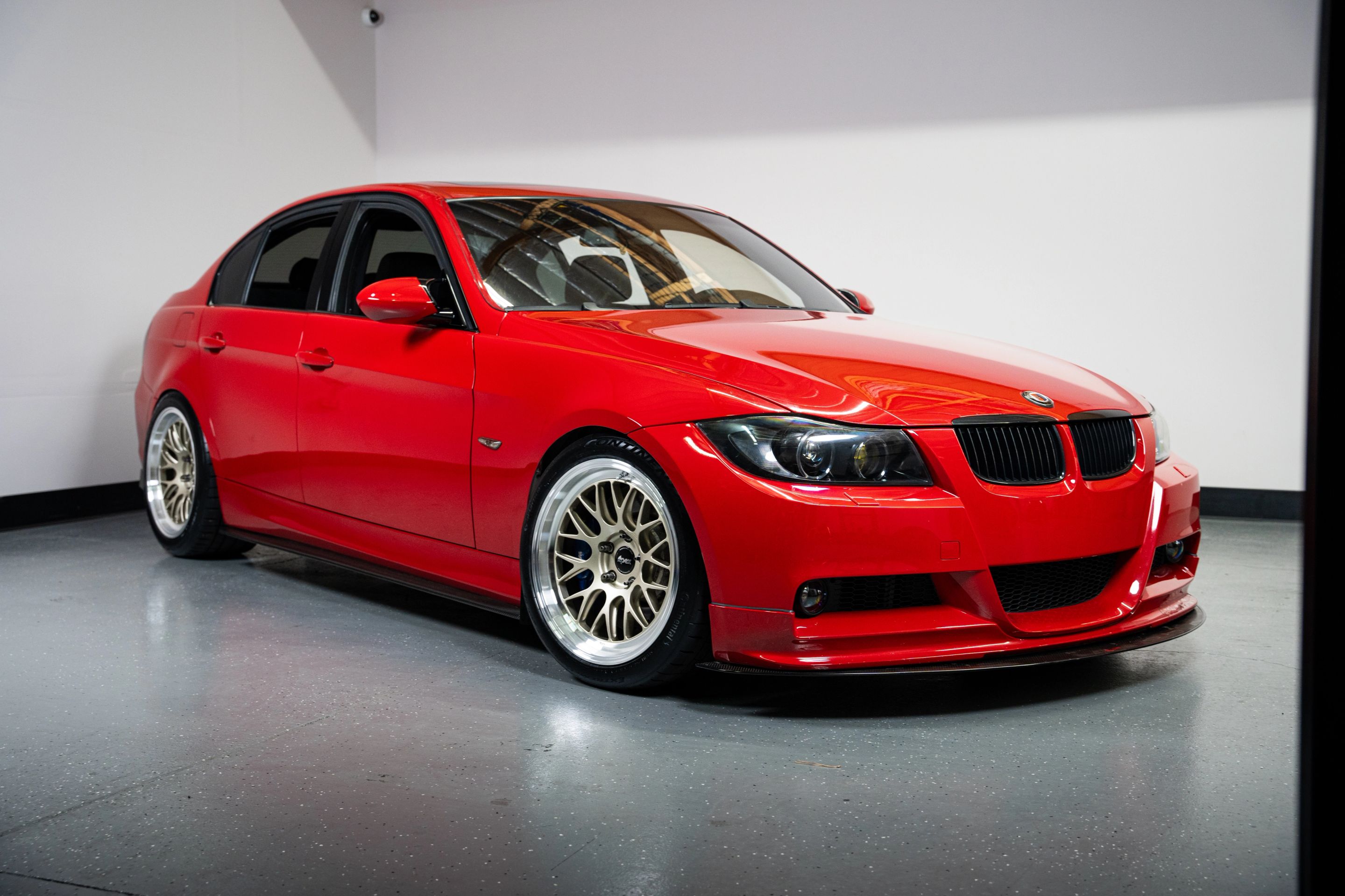 Red BMW E90 Sedan 3 Series with 18" ML-10RT Apex wheels in Machined Lip Gloss Motorsport Gold