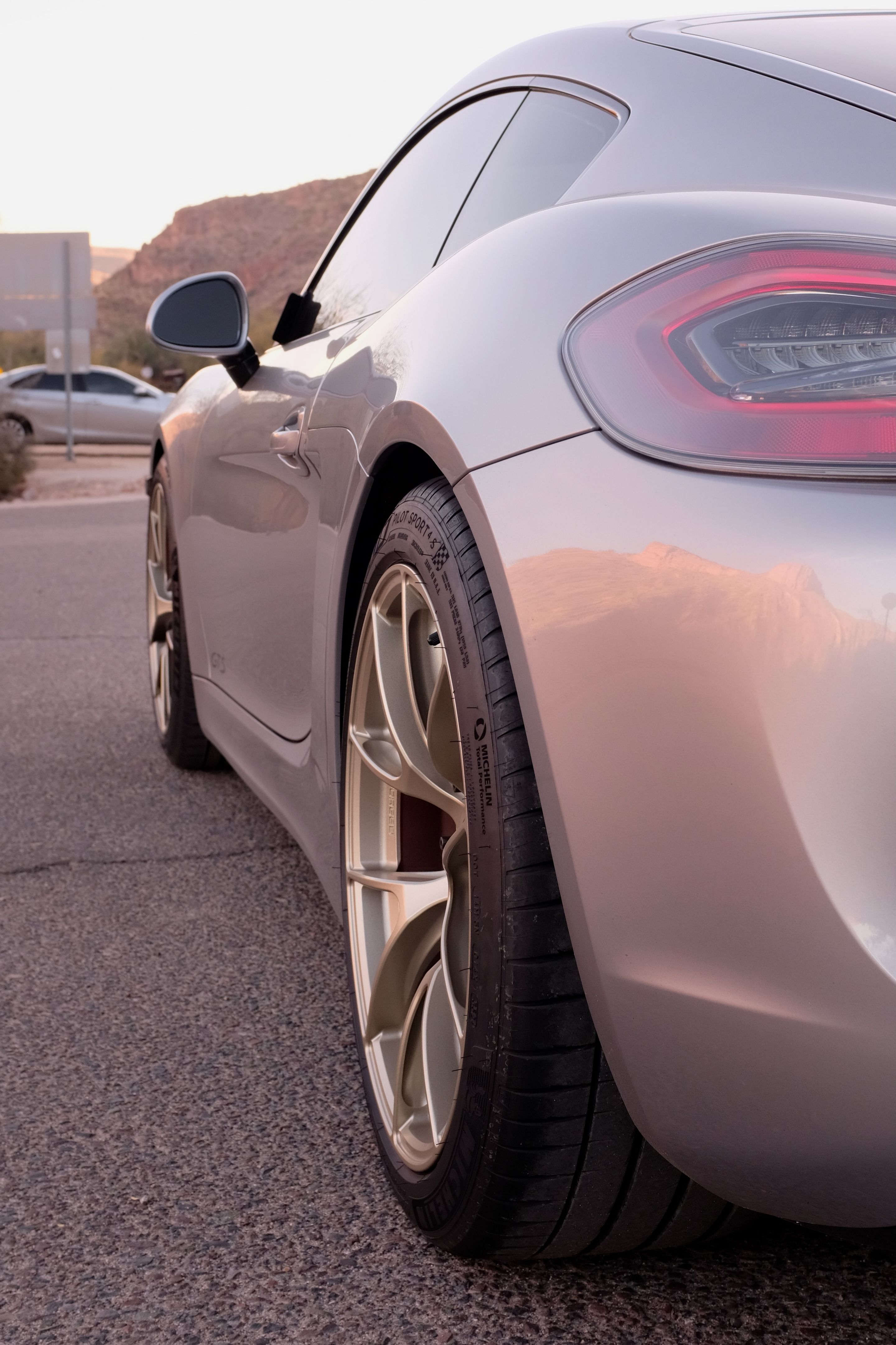 Silver Porsche 981 Cayman GTS with 19" VS-5RS Apex wheels in Motorsport Gold