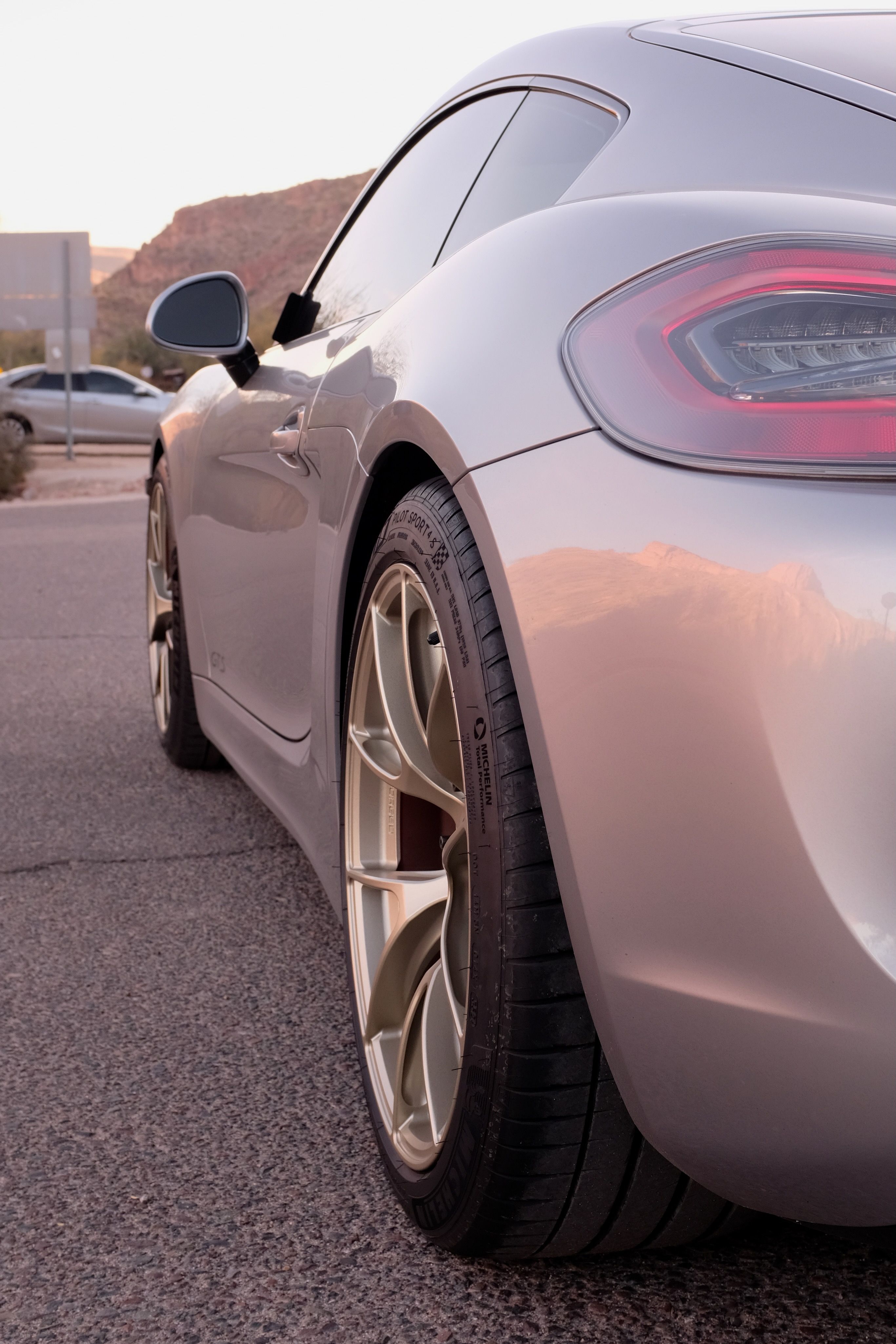 Silver Porsche 981 Cayman GTS with 19" VS-5RS Apex wheels in Motorsport Gold