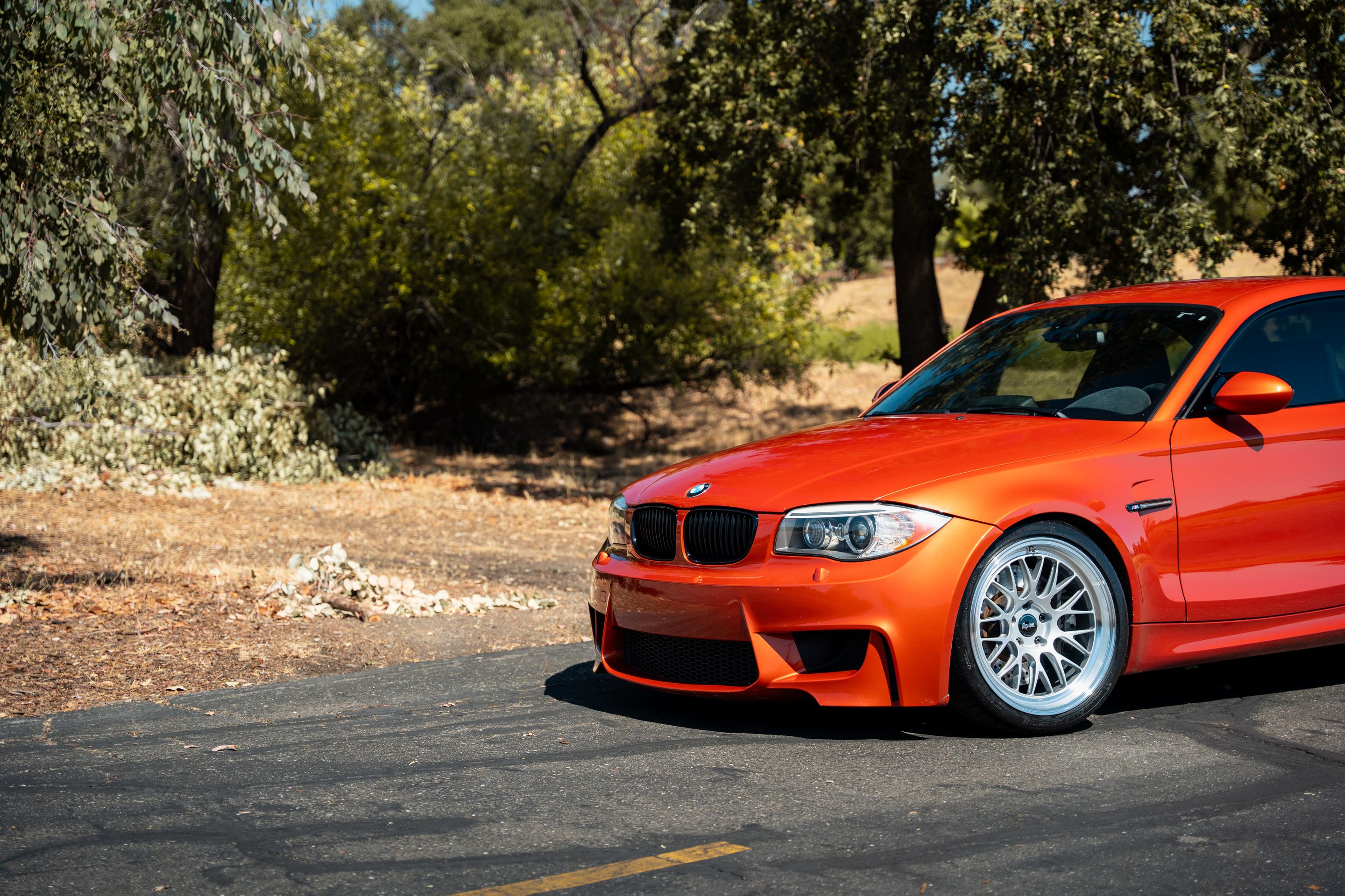 Orange BMW E82 1M with 19" ML-10RT Apex wheels in Machined Lip Race Silver