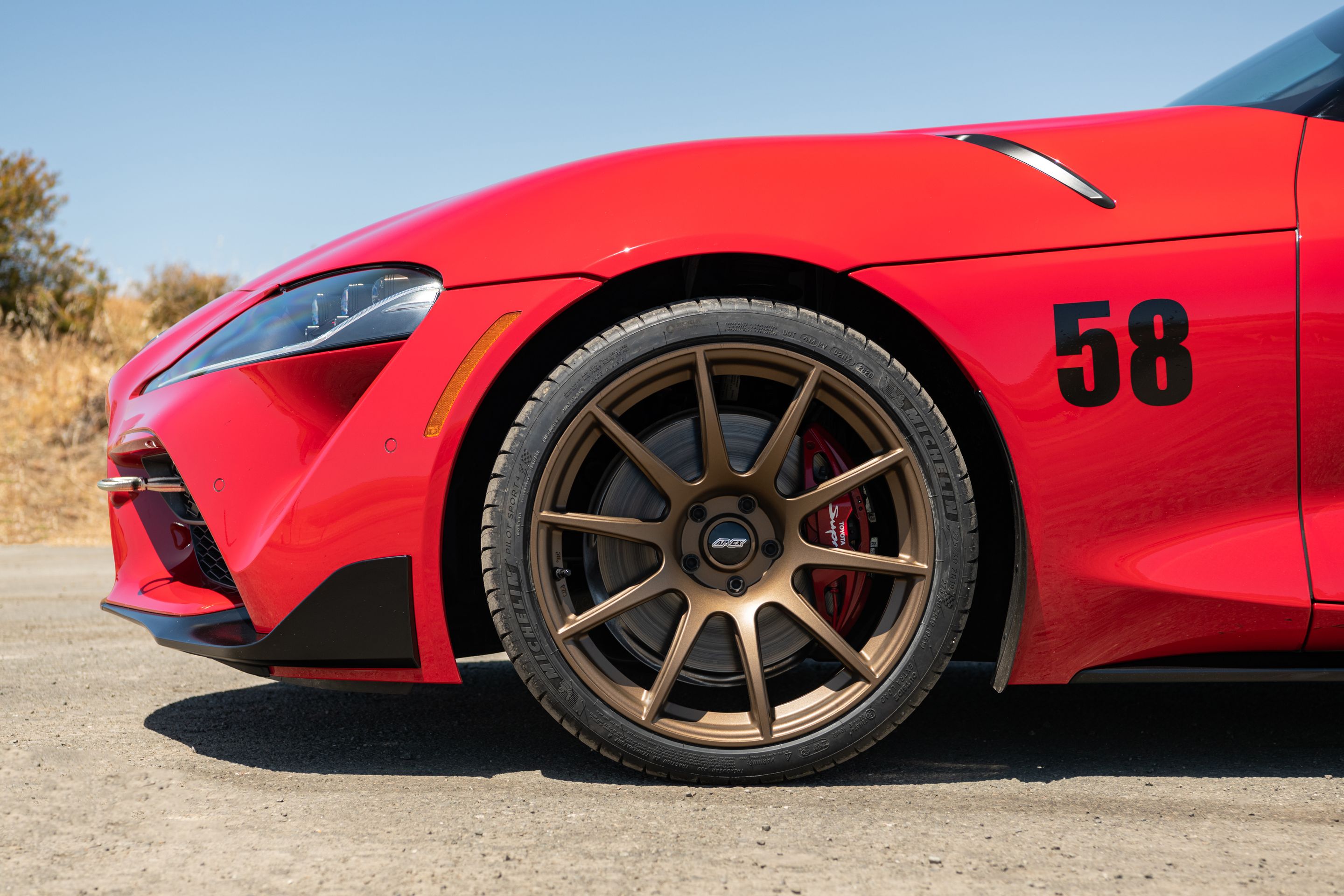 Red Toyota GR Supra with 19" SM-10 Apex wheels in Satin Bronze