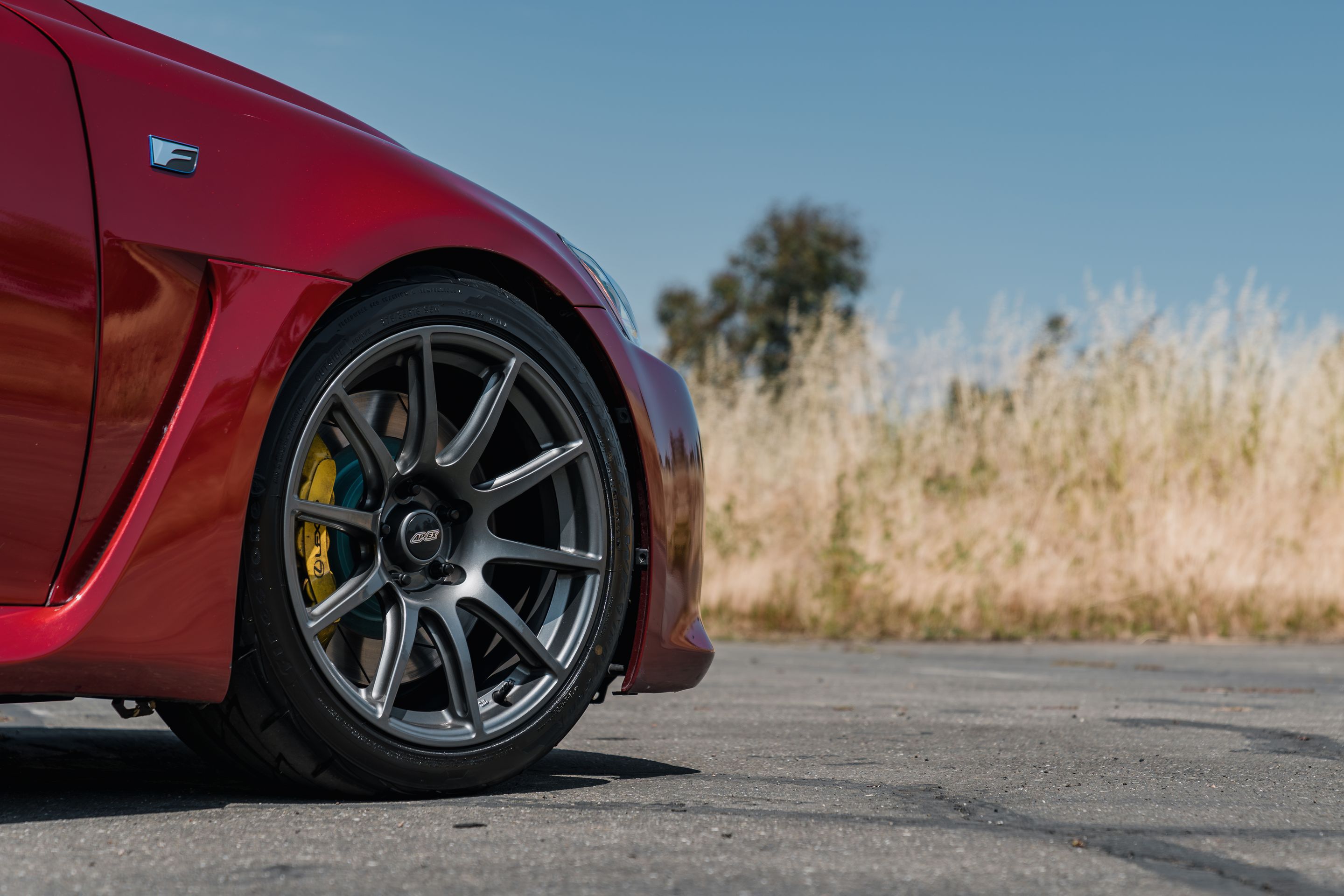 Red Lexus USE20 IS-F with 18" SM-10 Apex wheels in Anthracite