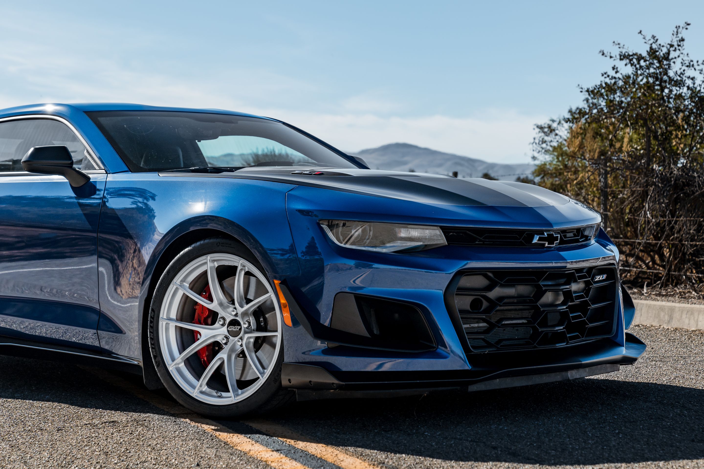 Blue Chevrolet 6th Gen Camaro ZL1 1LE with 20" VS-5RS Apex wheels in Brushed Clear