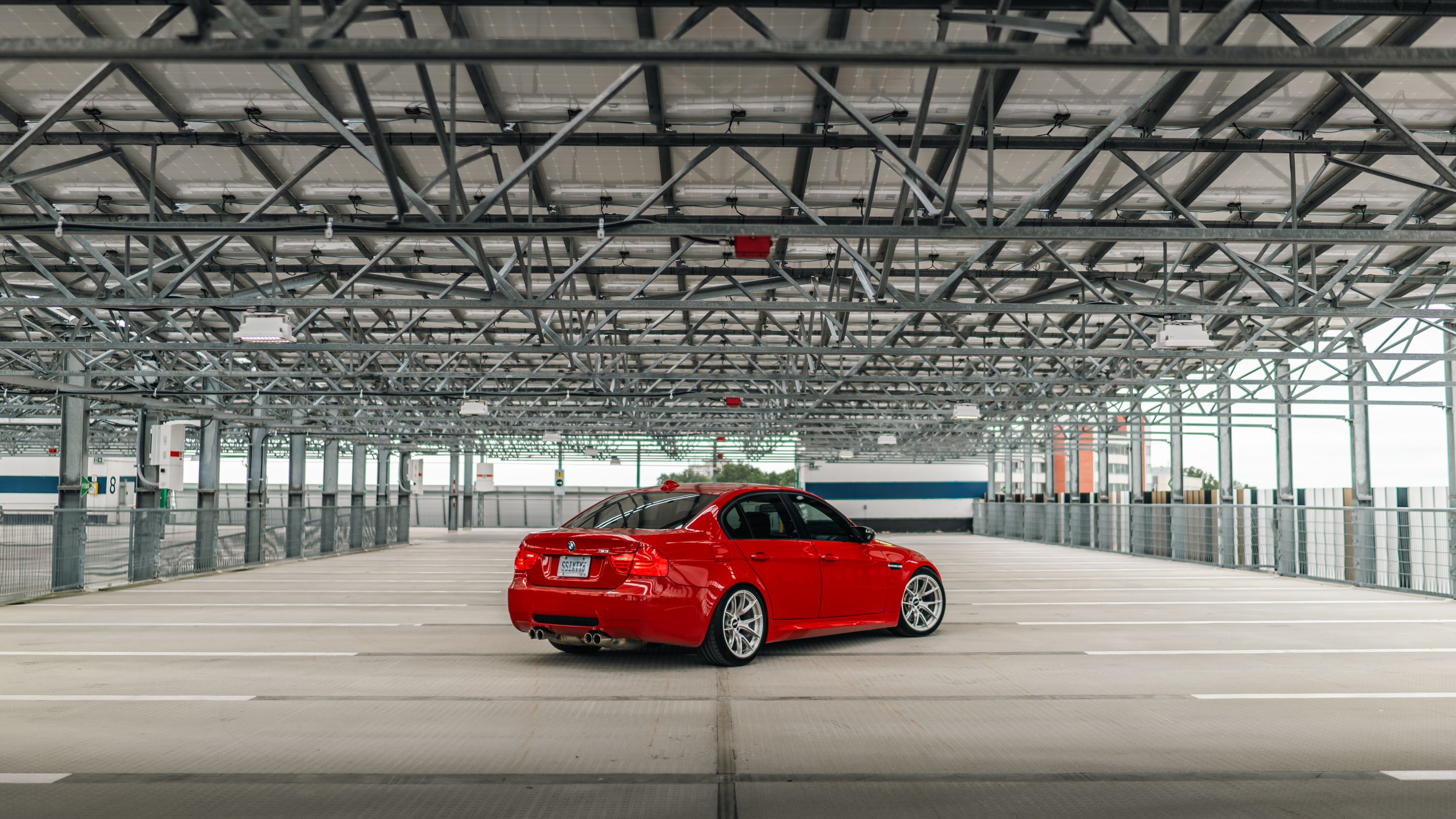 Red BMW E90 Sedan M3 with 18" VS-5RS Apex wheels in Brushed Clear