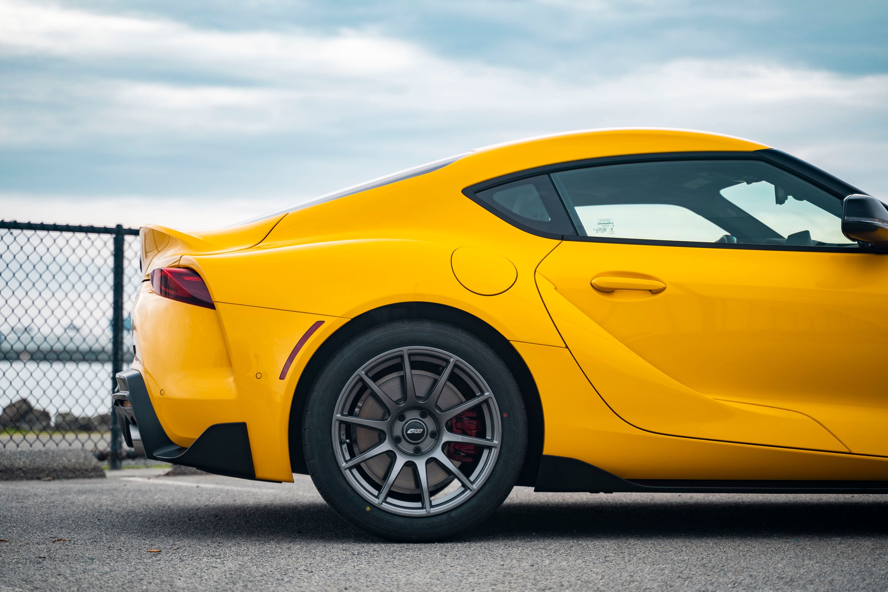 Yellow Toyota GR Supra with 18" SM-10 Apex wheels in Anthracite