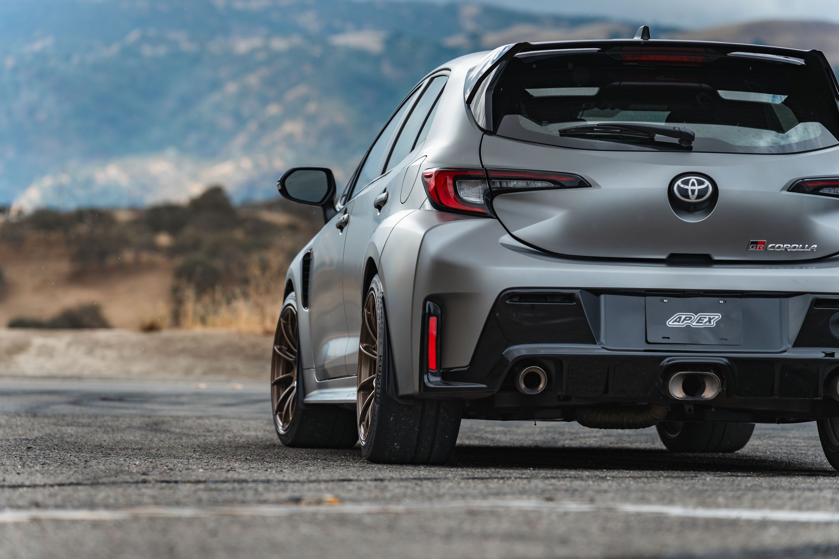 Grey Toyota GR Corolla with 18" SM-10RS Apex wheels in Satin Bronze