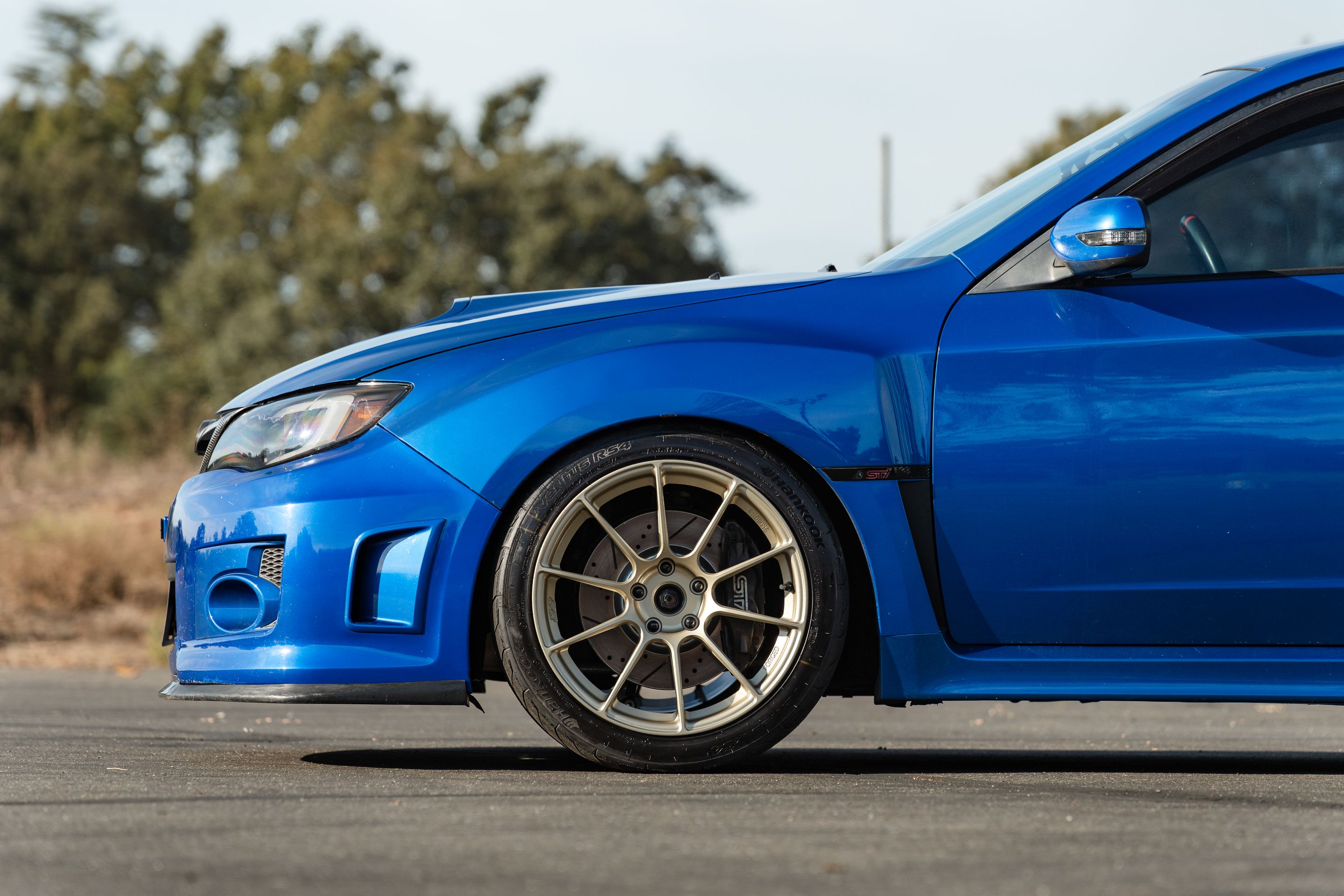 Blue Subaru GR WRX STI with 18" SM-10RS Apex wheels in Motorsport Gold