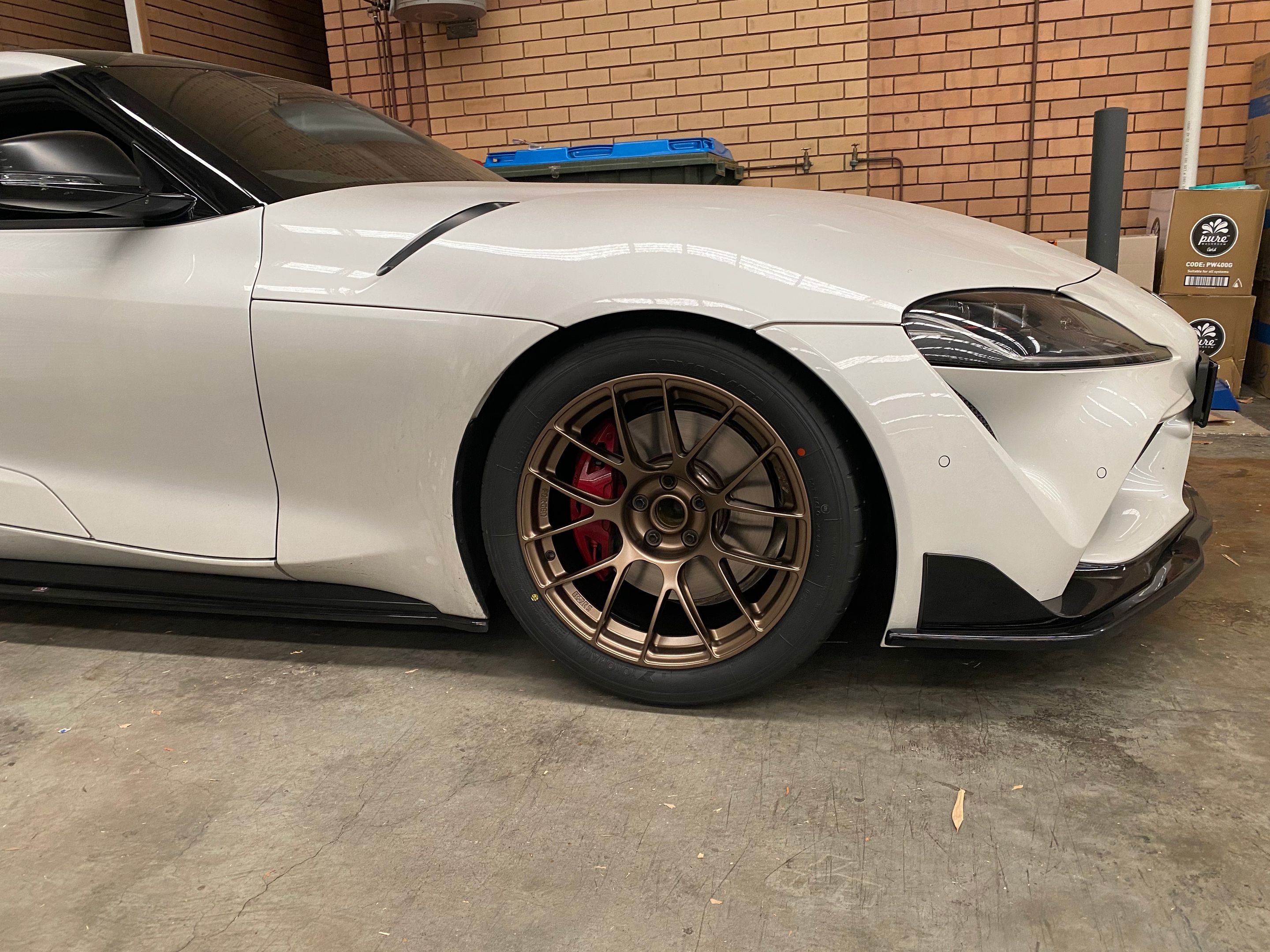 White Toyota GR Supra with 18" EC-7RS Apex wheels in Satin Bronze