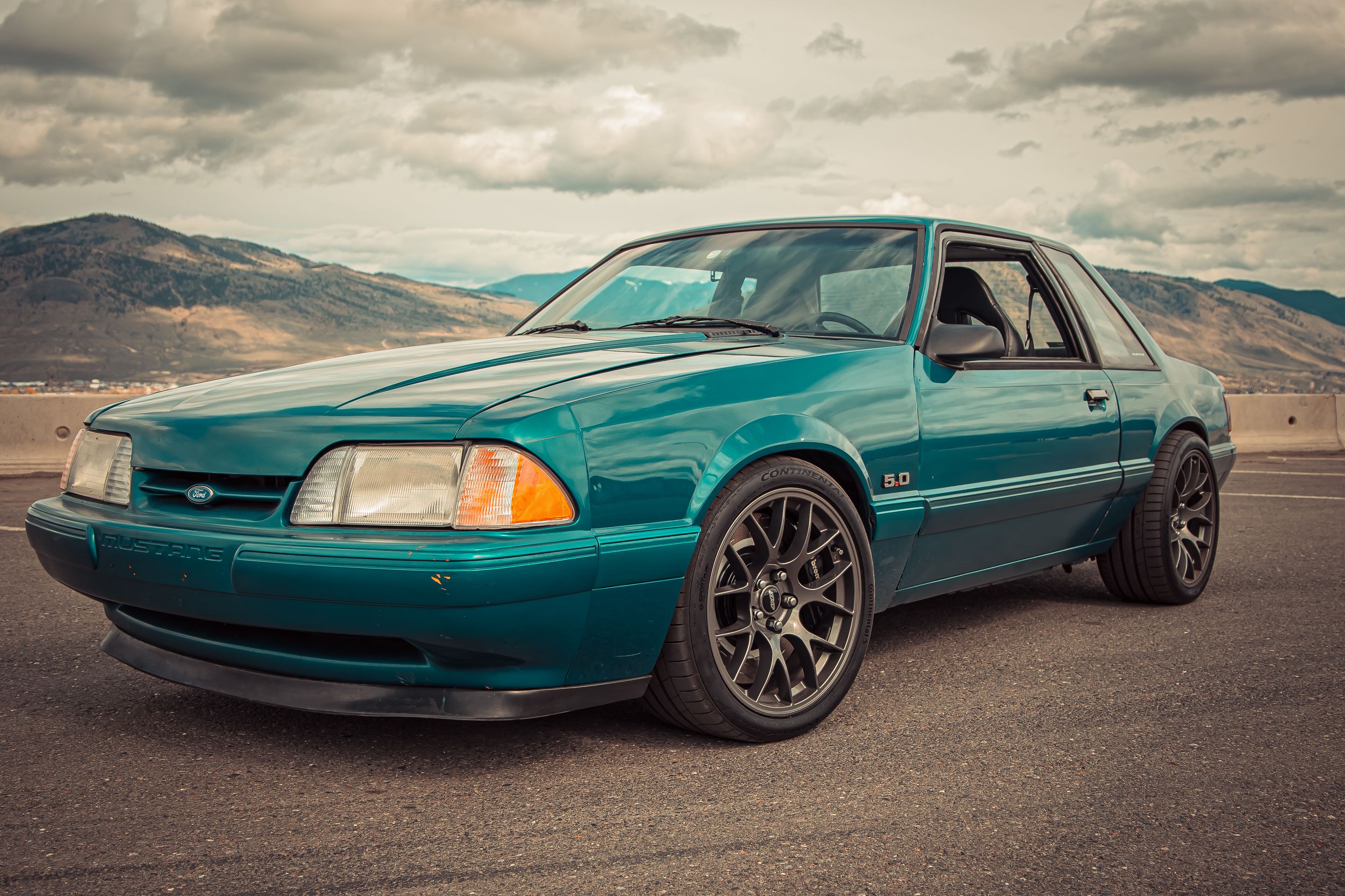 Green Ford SN95 Mustang GT with 18" EC-7 Apex wheels in Anthracite