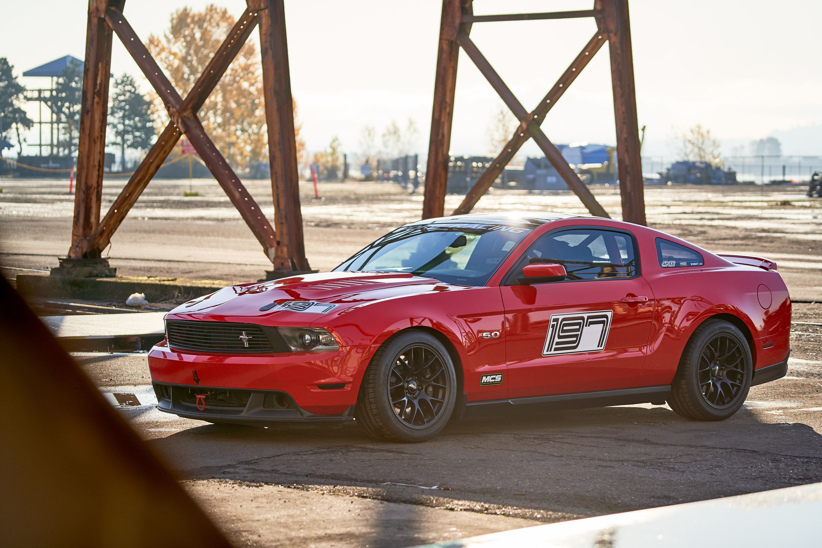 Red Ford S197 Mustang GT with 18" EC-7 Apex wheels in Satin Black