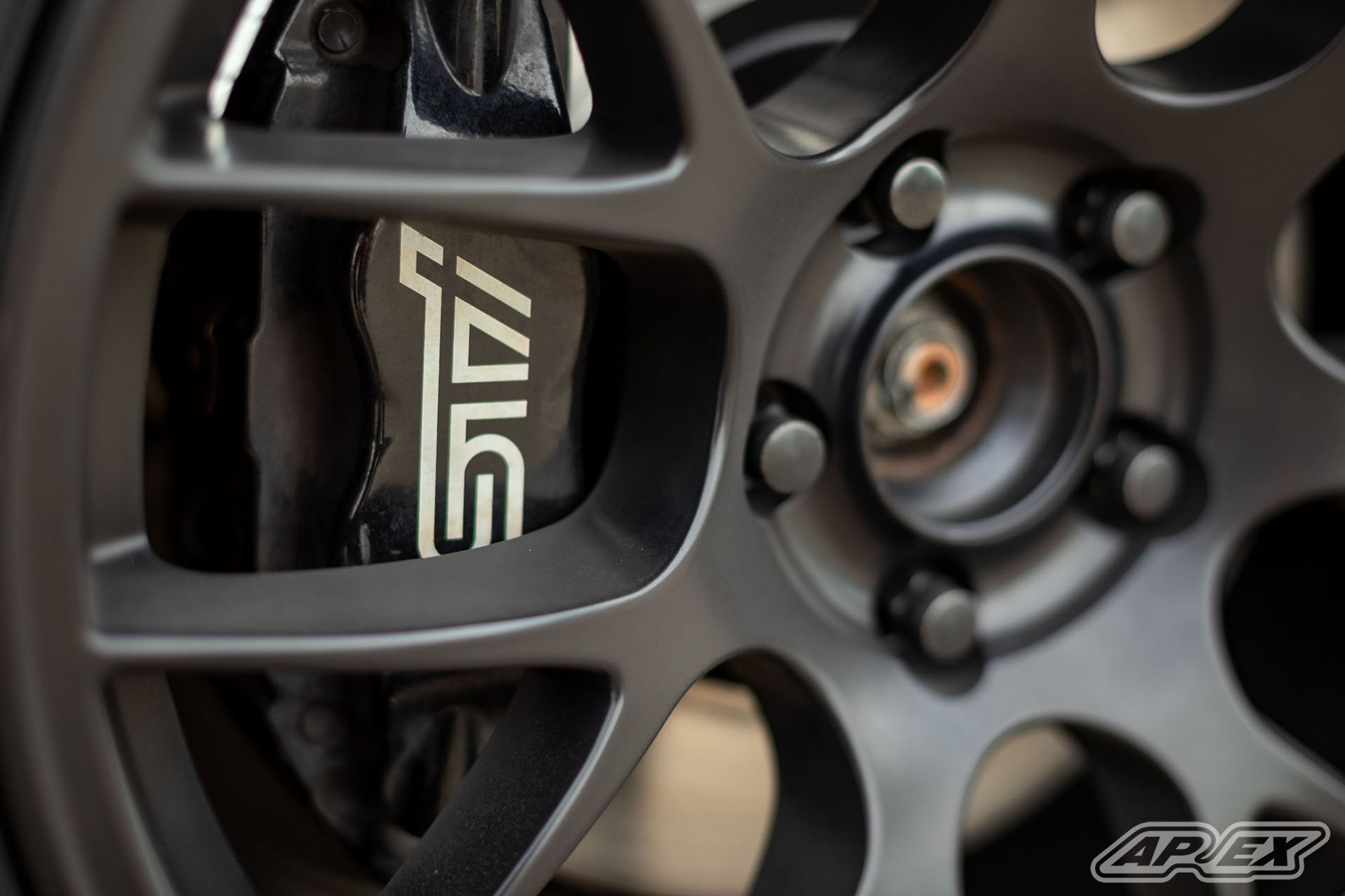 Orange Subaru GR WRX STI with 18" EC-7 Apex wheels in Satin Black