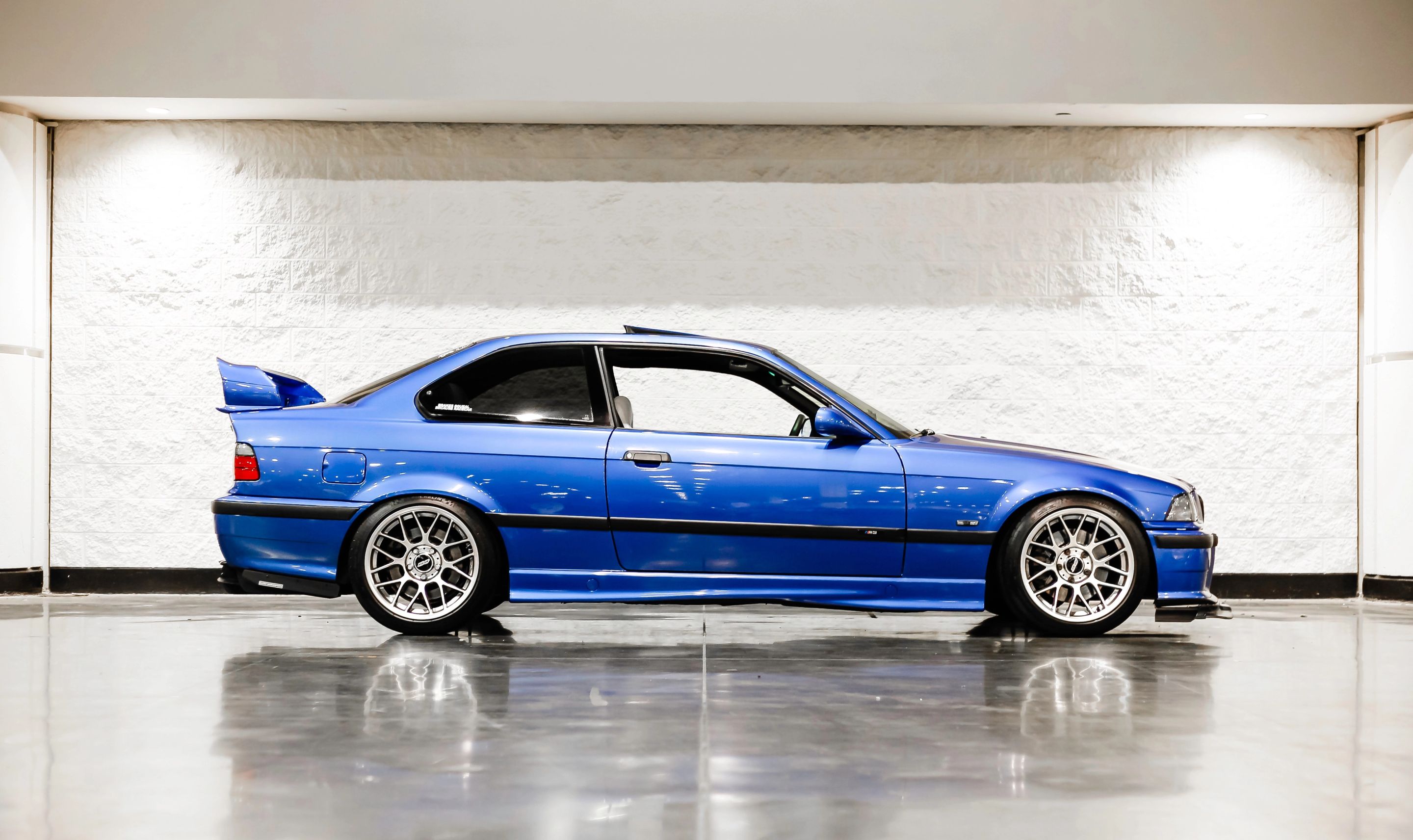 Blue BMW E36 M3 with 17" ARC-8 Apex wheels in Hyper Black