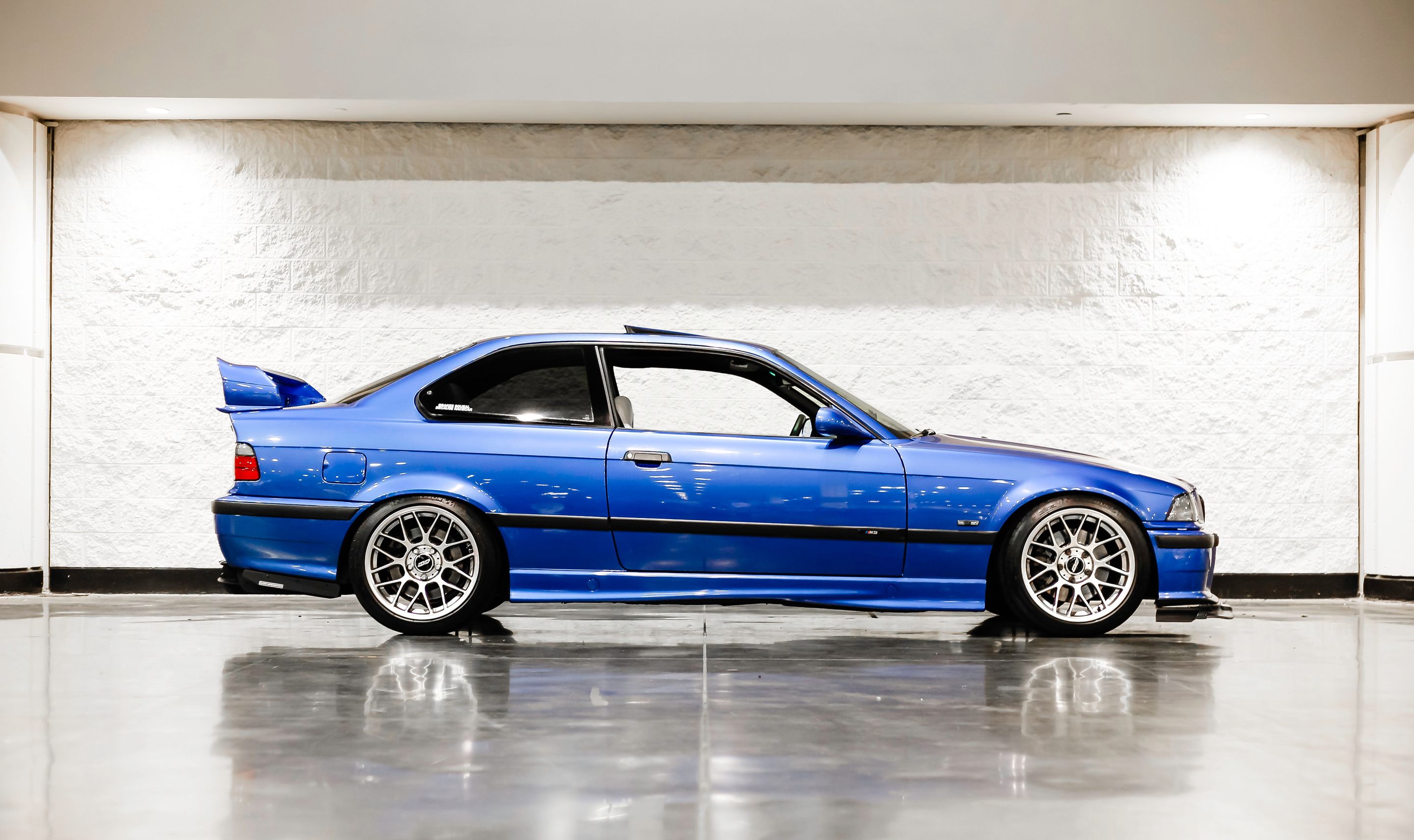 Blue BMW E36 M3 with 17" ARC-8 Apex wheels in Hyper Black