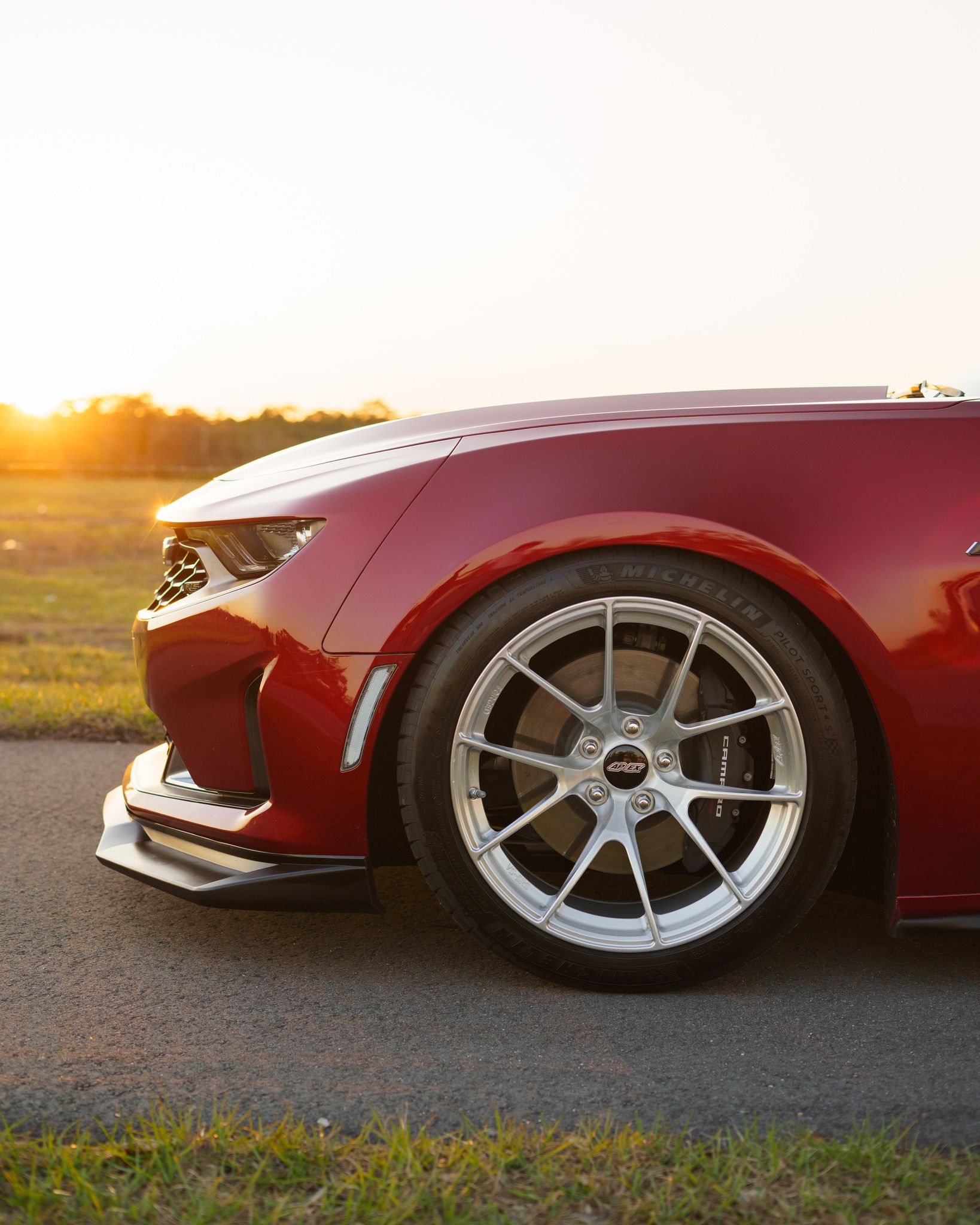 Red Chevrolet 6th Gen Camaro LT1 with 19" VS-5RS Apex wheels in Brushed Clear