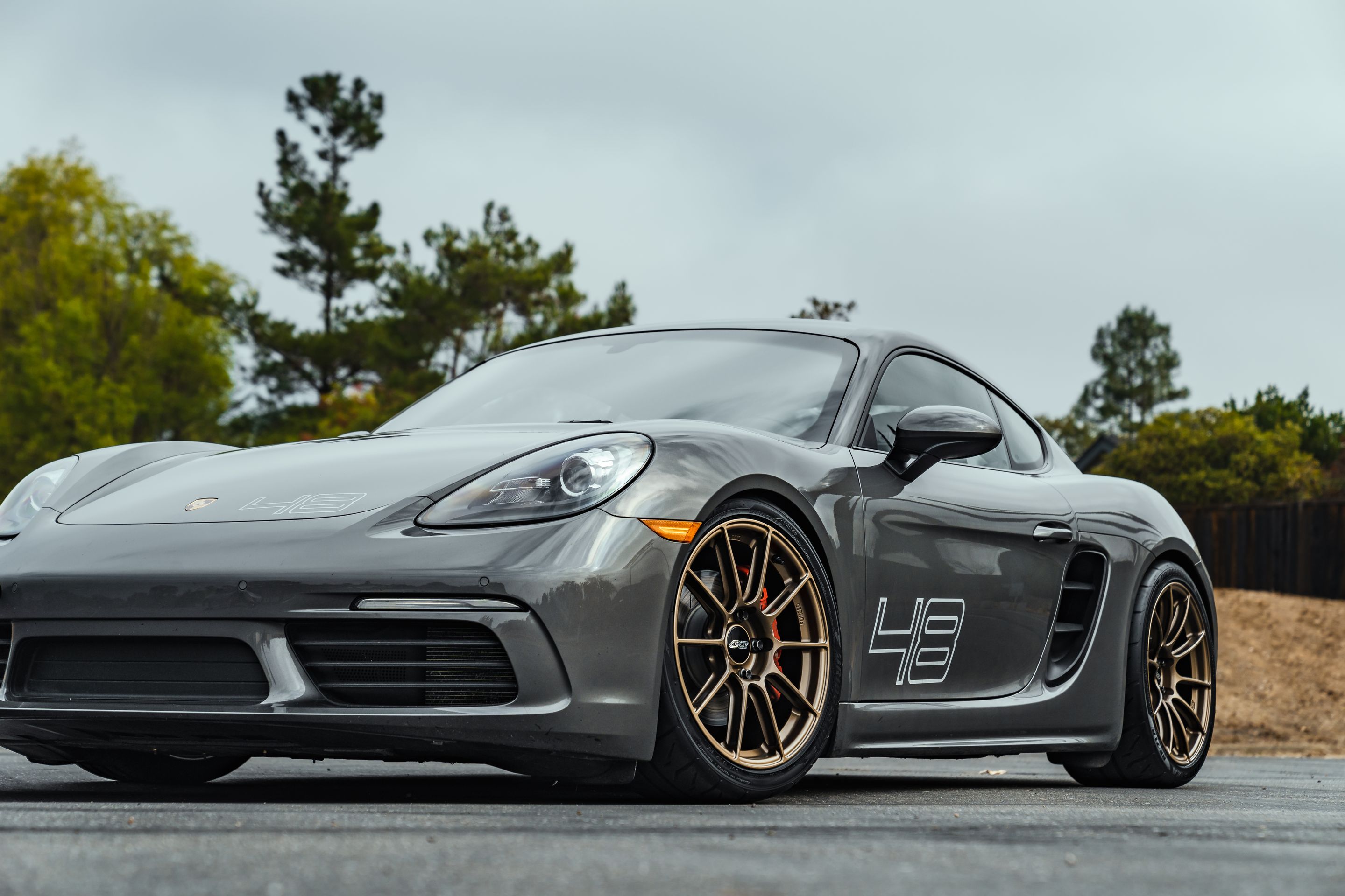 Grey Porsche 718 Cayman S with 19" SM-10RS Apex wheels in Satin Bronze