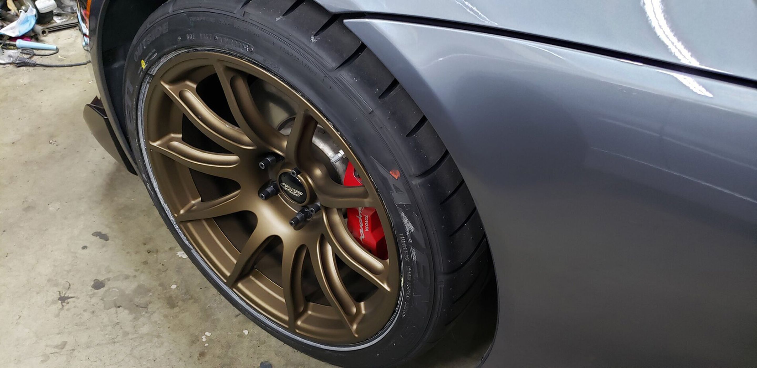 Grey Toyota GR Supra with 18" SM-10 Apex wheels in Satin Bronze